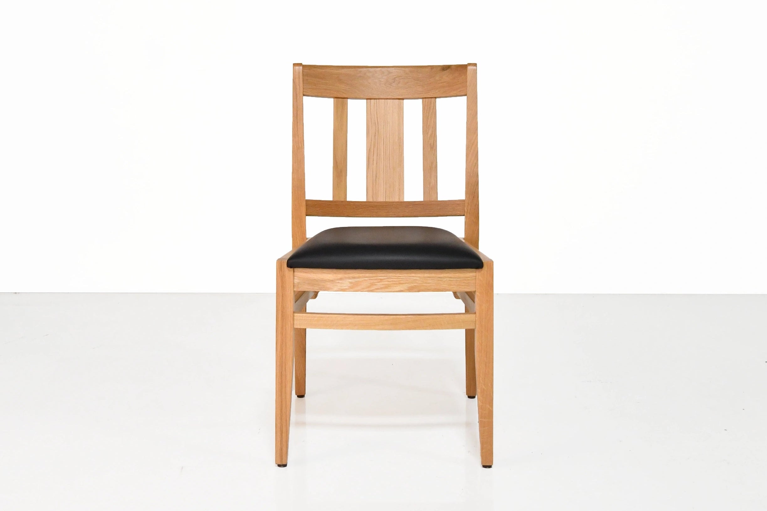 Wooden chair with black seat on a white background
