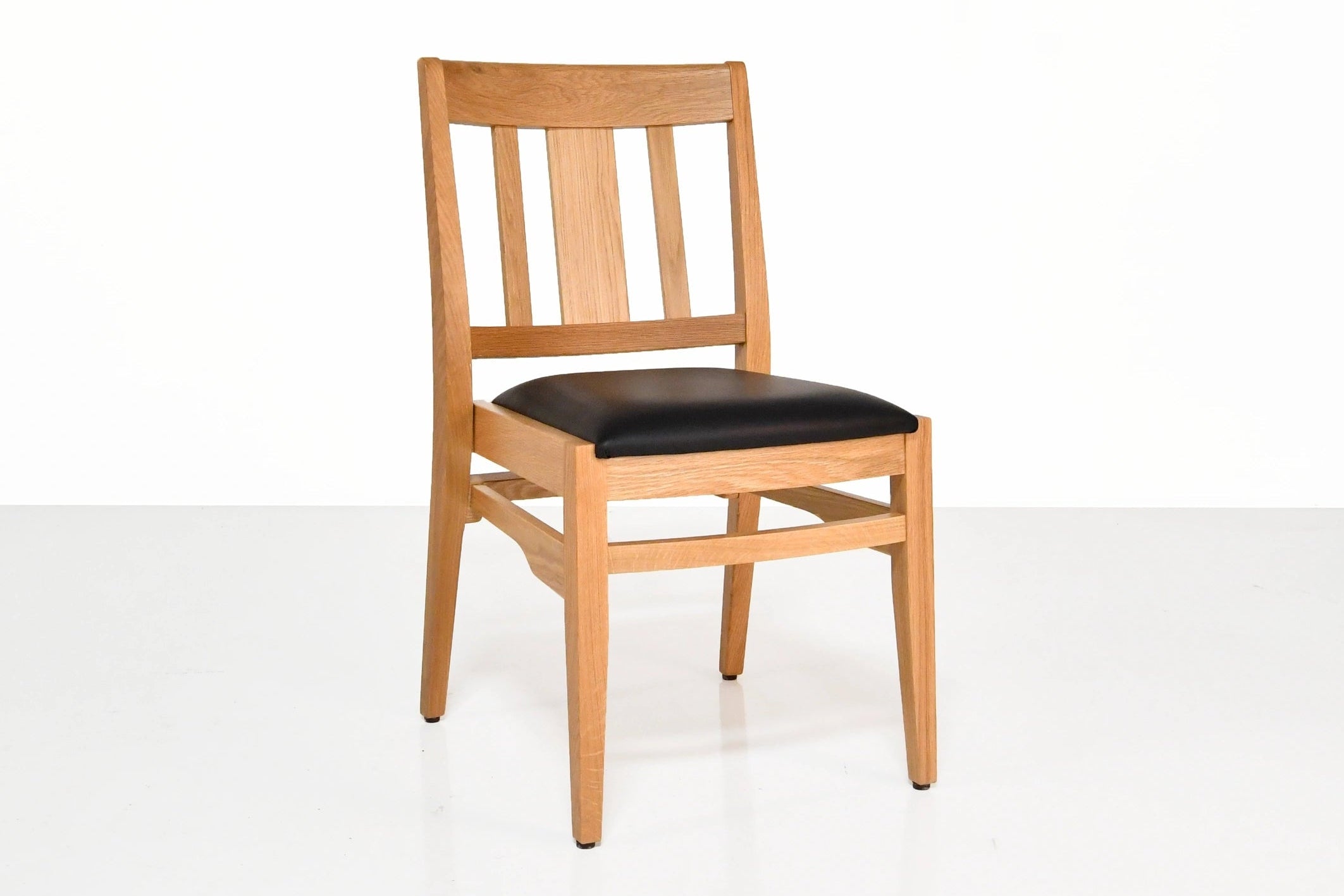 Wooden chair with a black seat on a white background