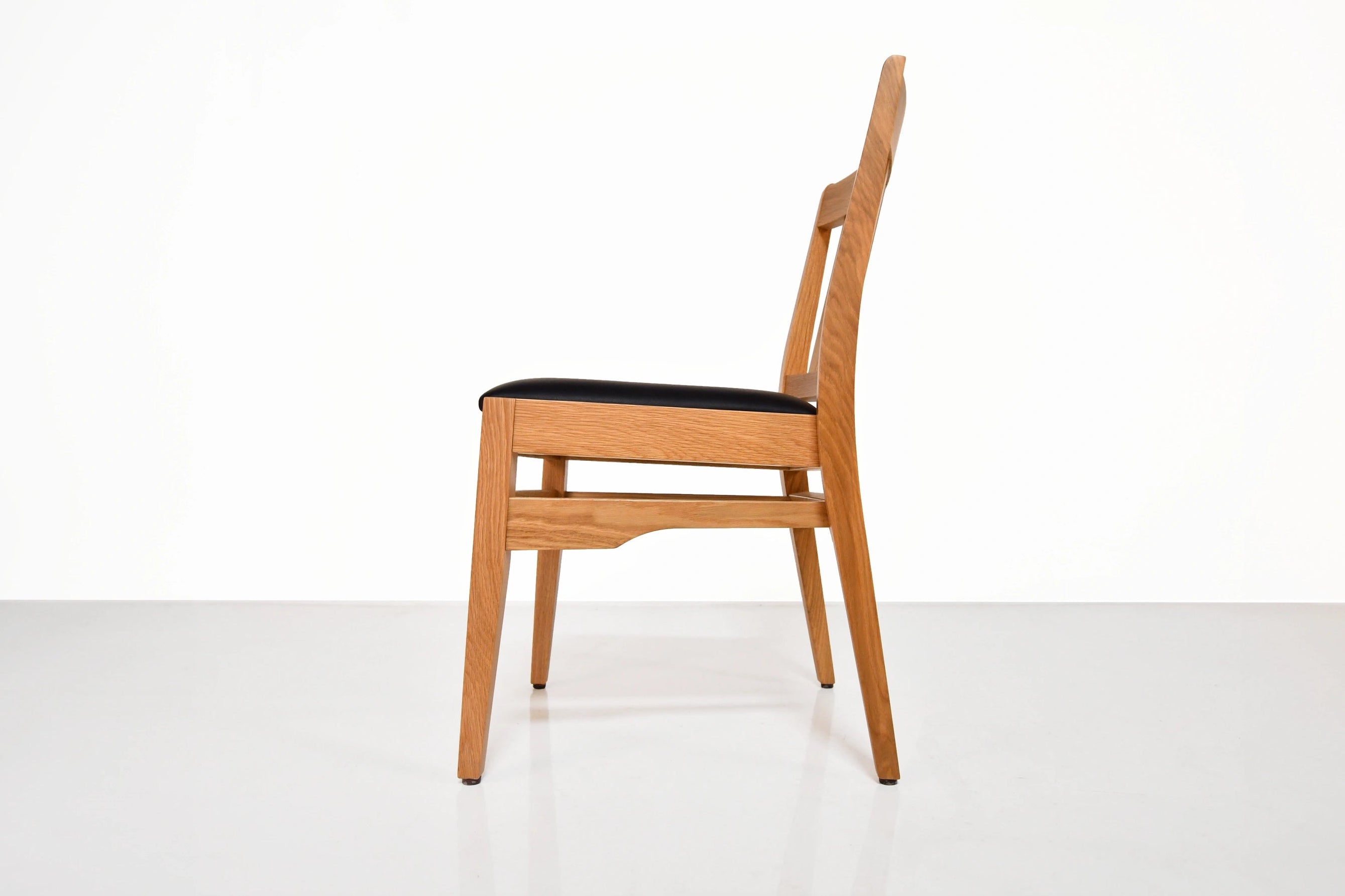 Wooden chair with black seat on a white background