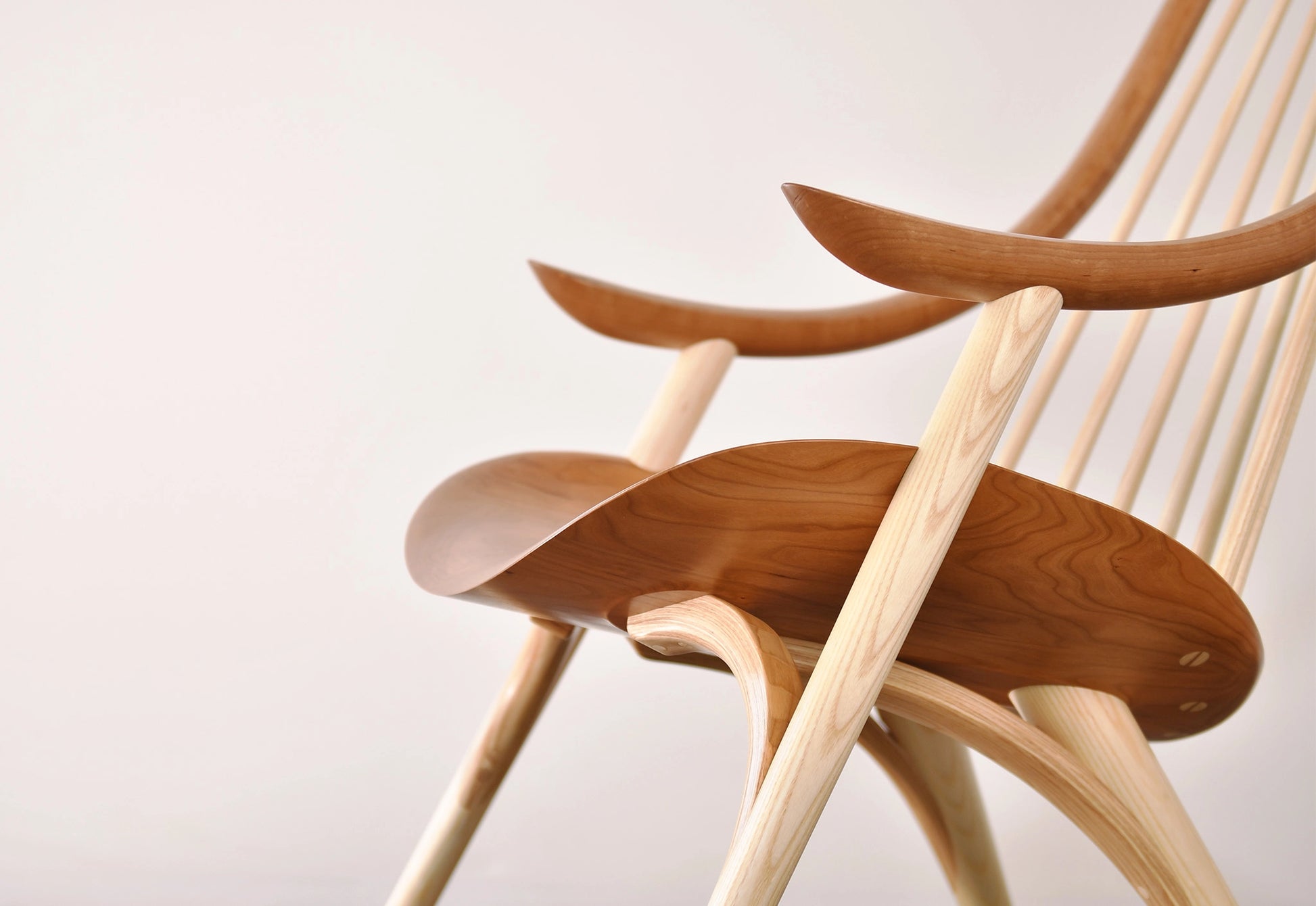 Wooden chair with a curved design on a light background