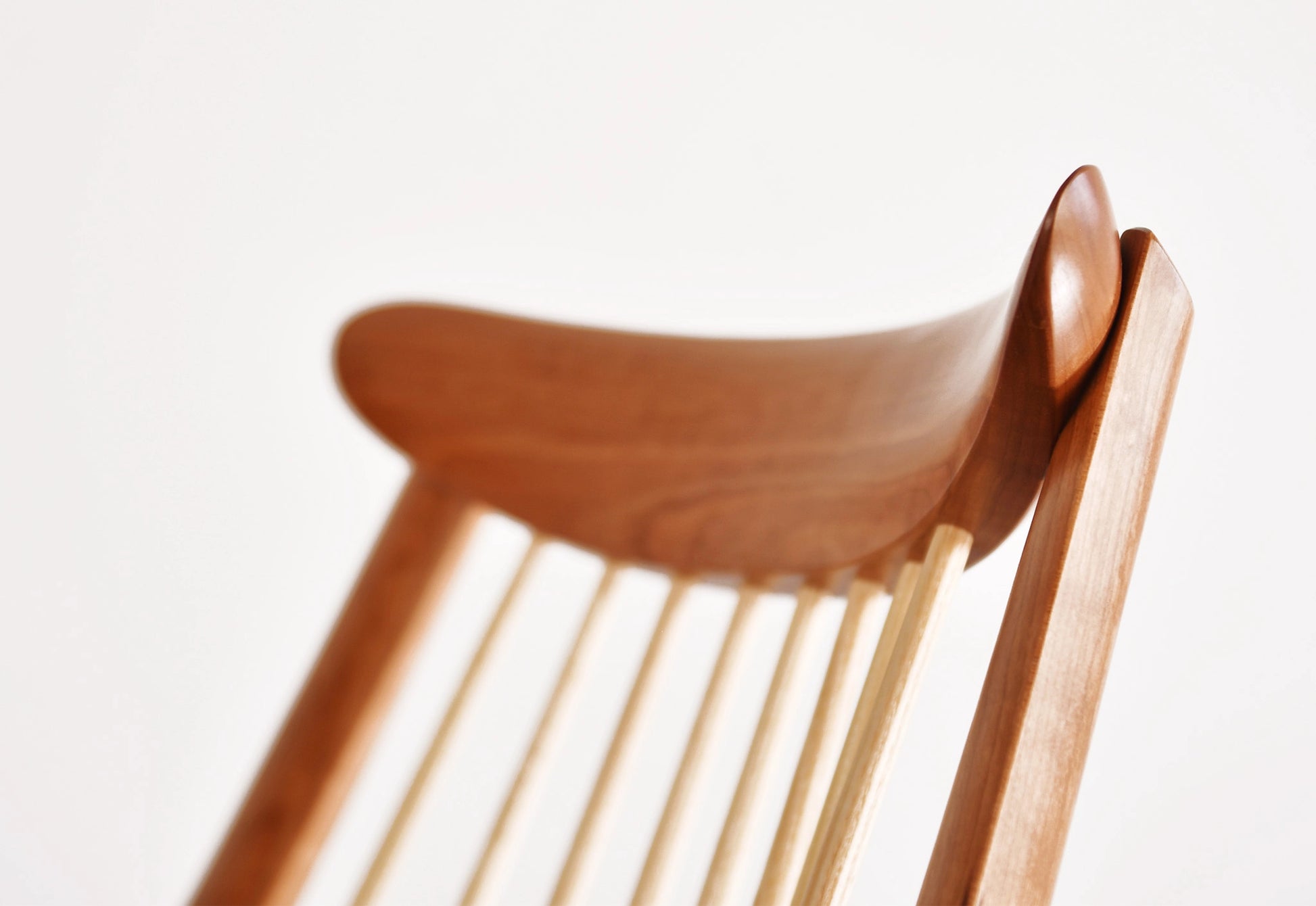 Wooden chair with a curved backrest on a white background