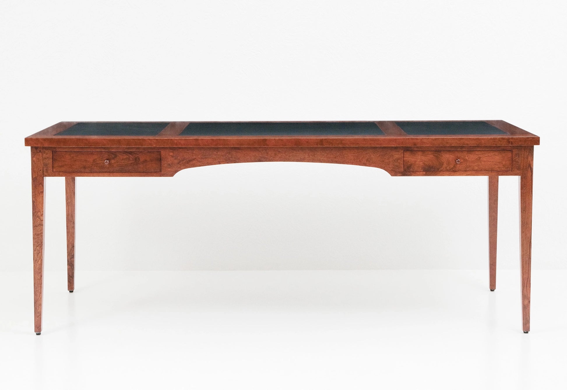 Wooden desk with a black top on a white background