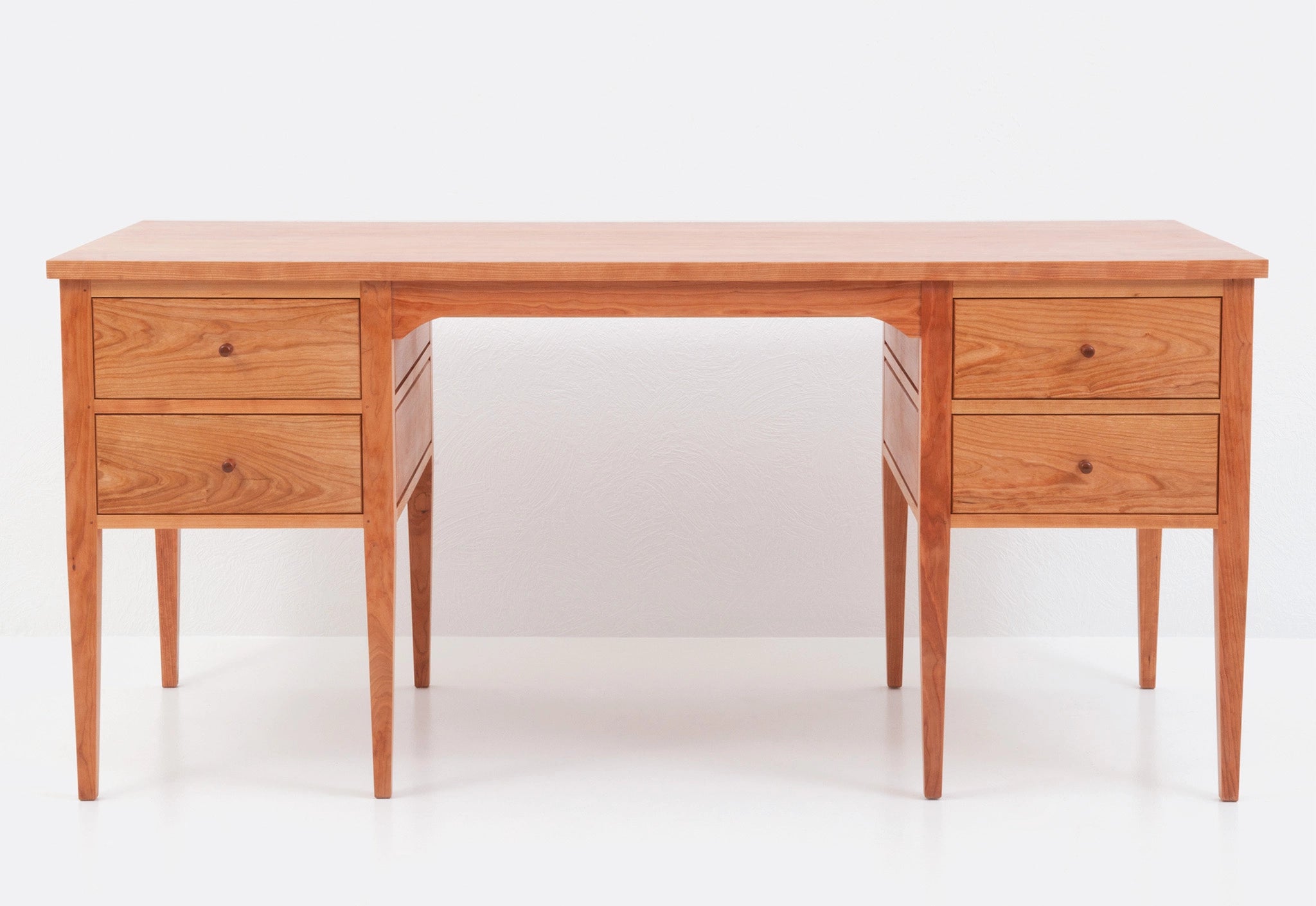Wooden desk with drawers on a white background