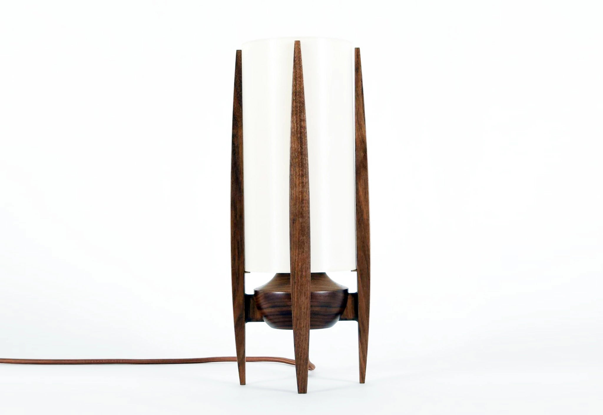 Wooden lamp with three tall, thin legs on a white background