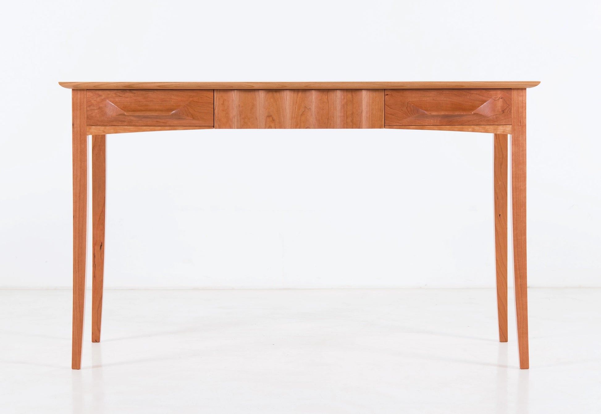 Wooden desk with drawers on a white background