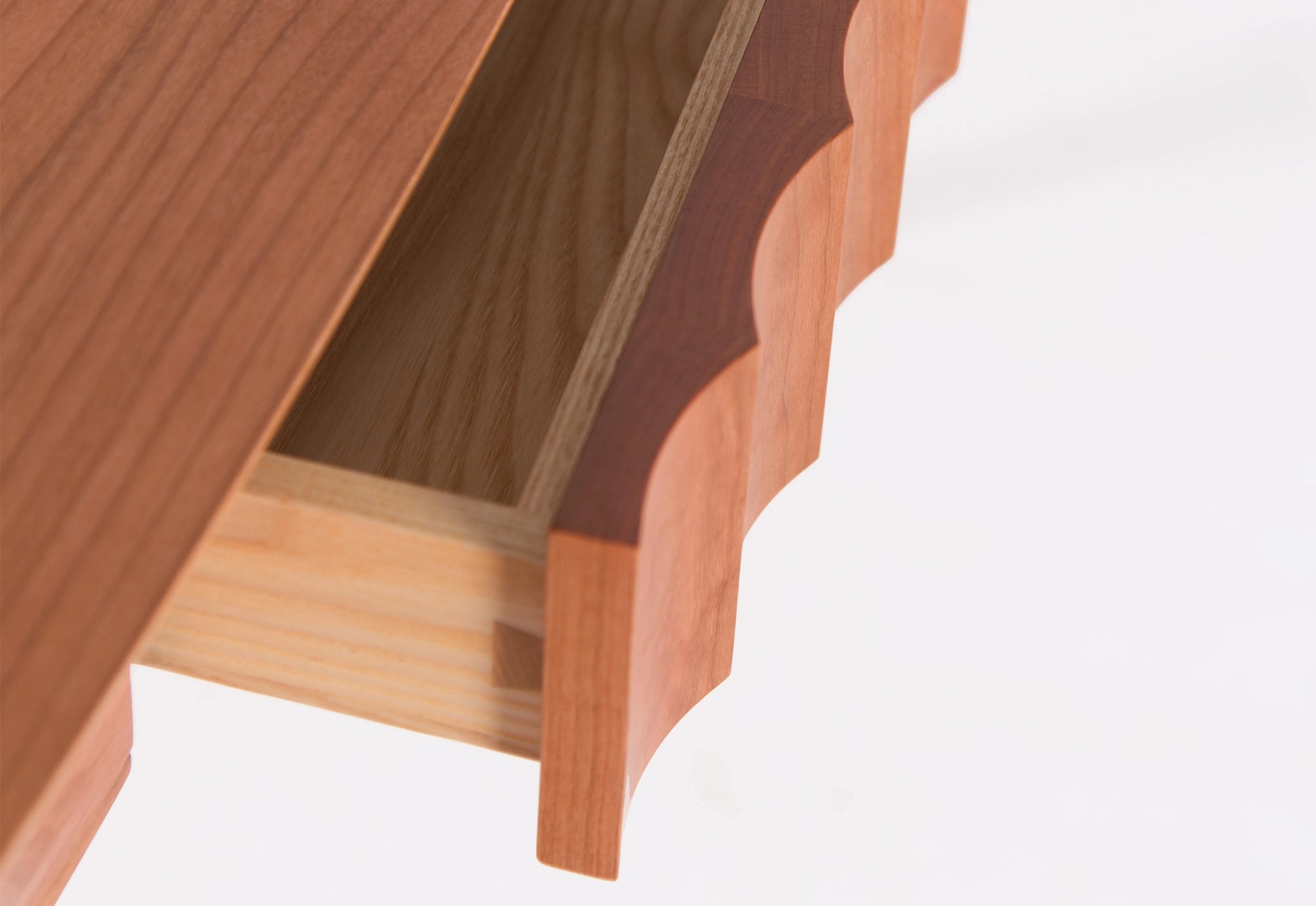 Close-up of a wooden desk with a visible grain pattern on a white background