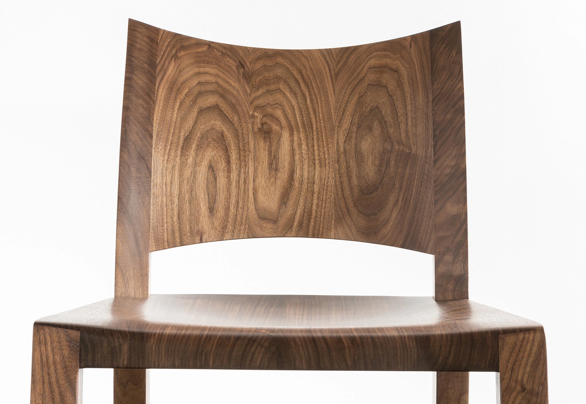 Wooden chair with a curved backrest on a white background