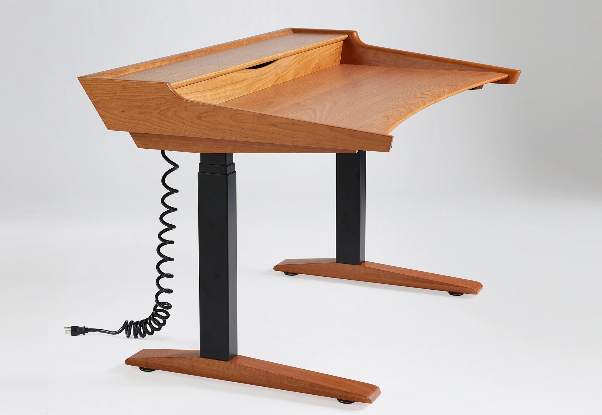 Wooden adjustable desk with black stand on a white background