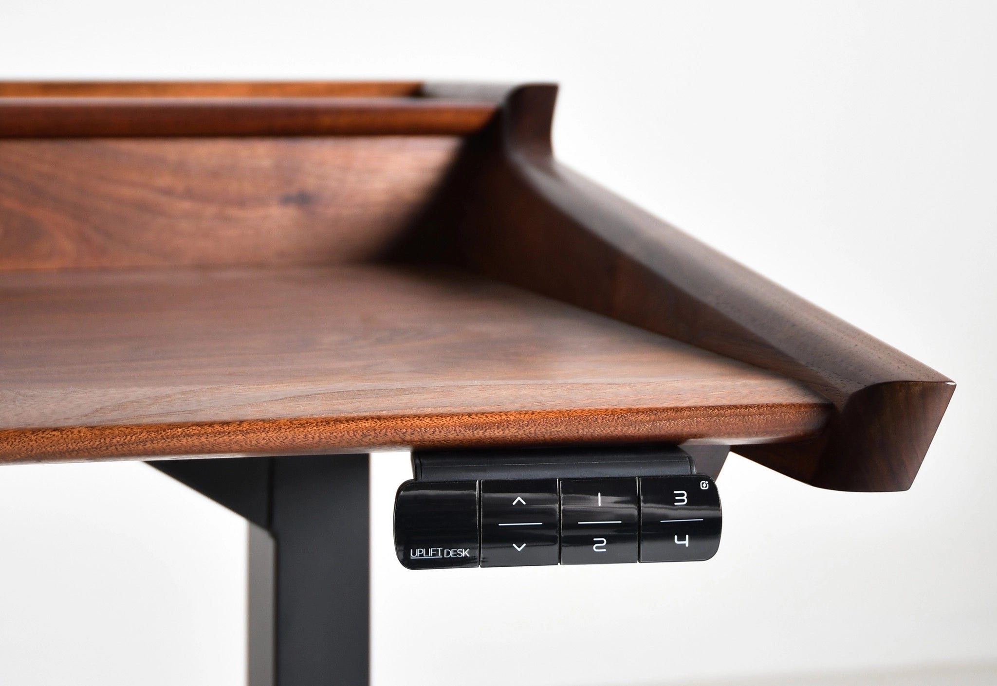 Wooden adjustable desk with height control panel on a white background