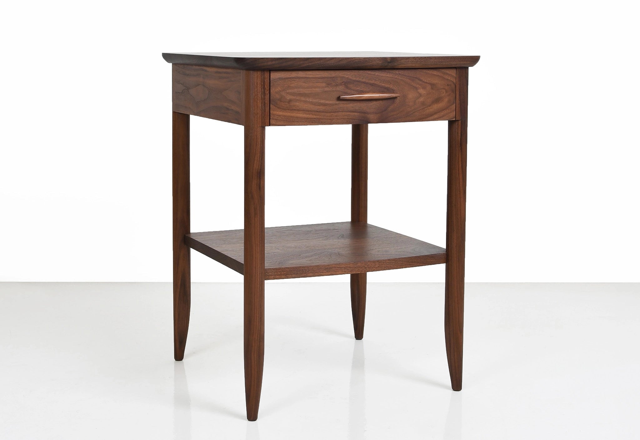 Wooden side table with a drawer on a white background
