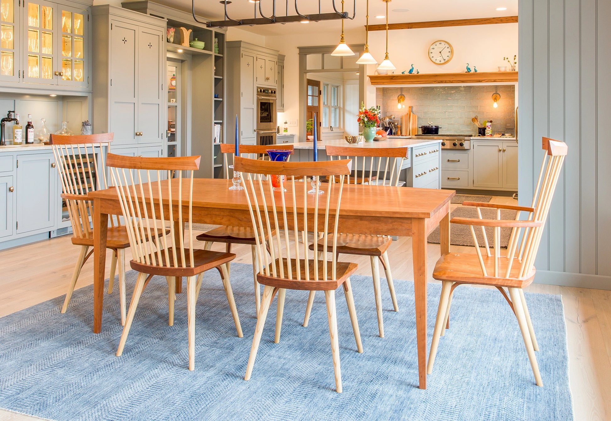 Wooden dining table with chairs in a kitchen setting