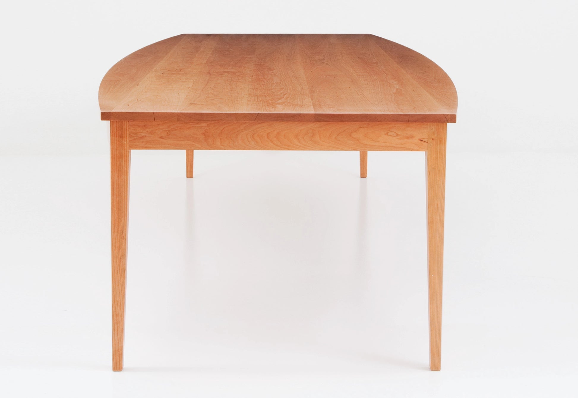 Wooden dining table on a white background