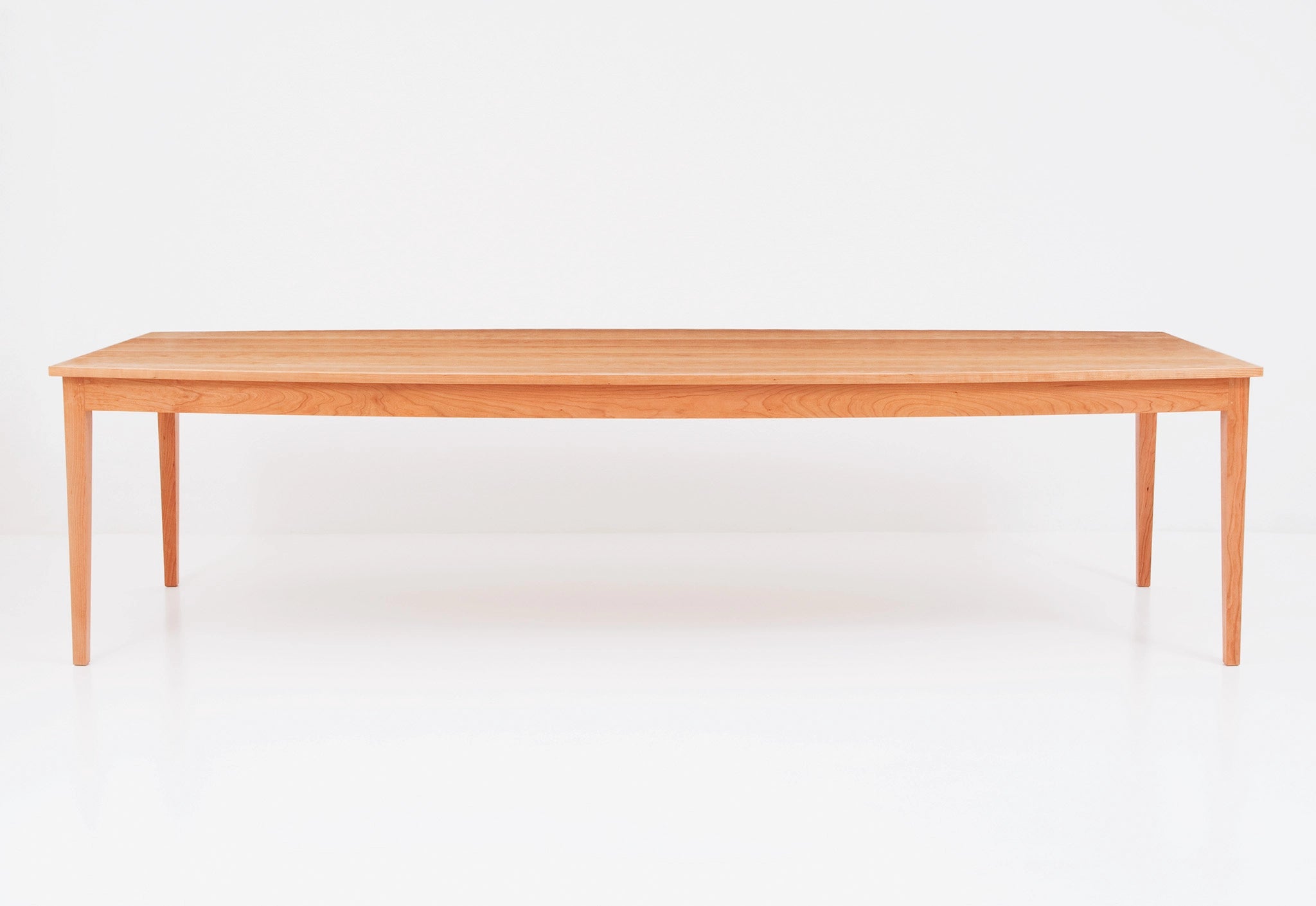Wooden dining table on a white background