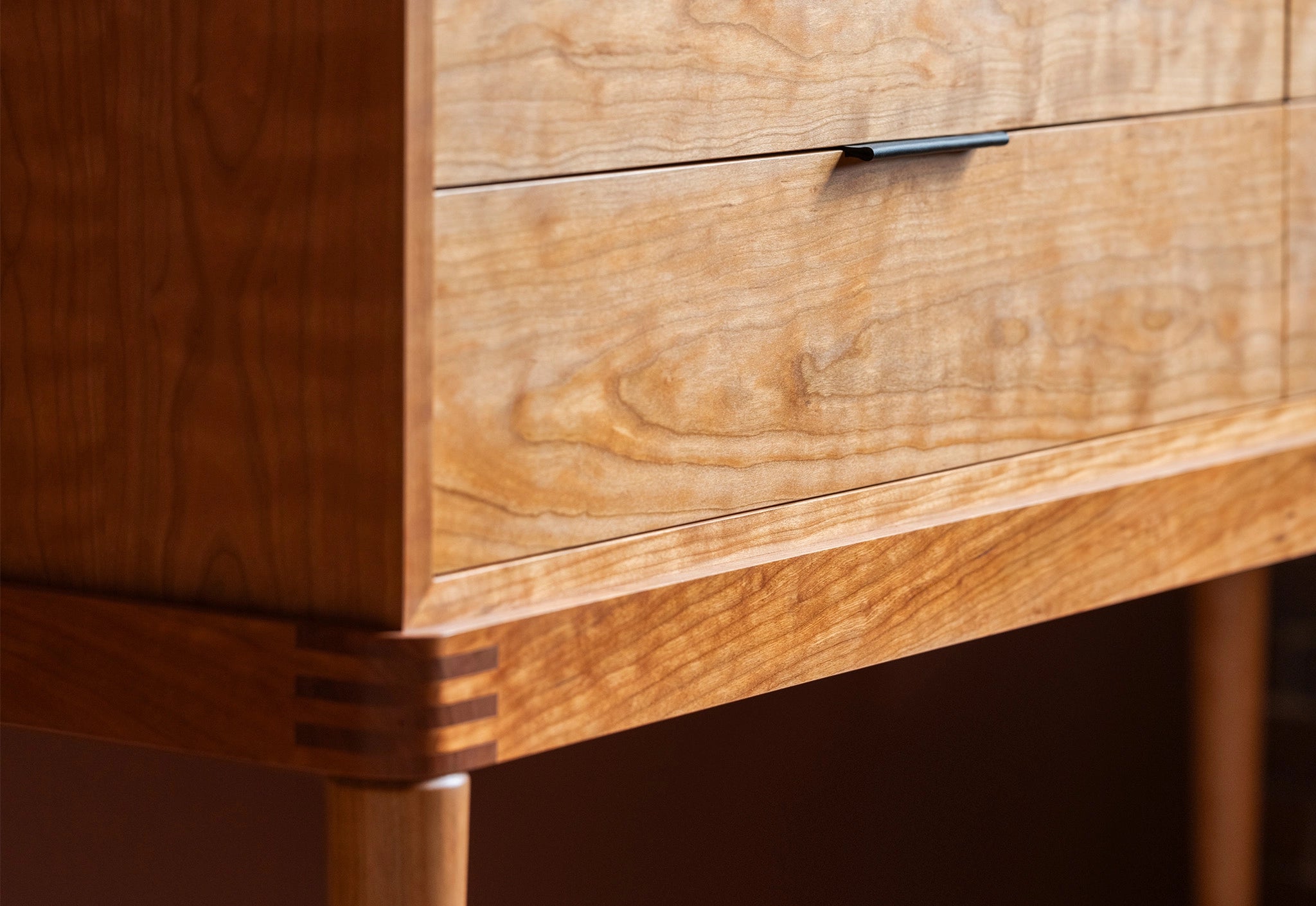 Close-up of a wooden drawer with a visible grain pattern