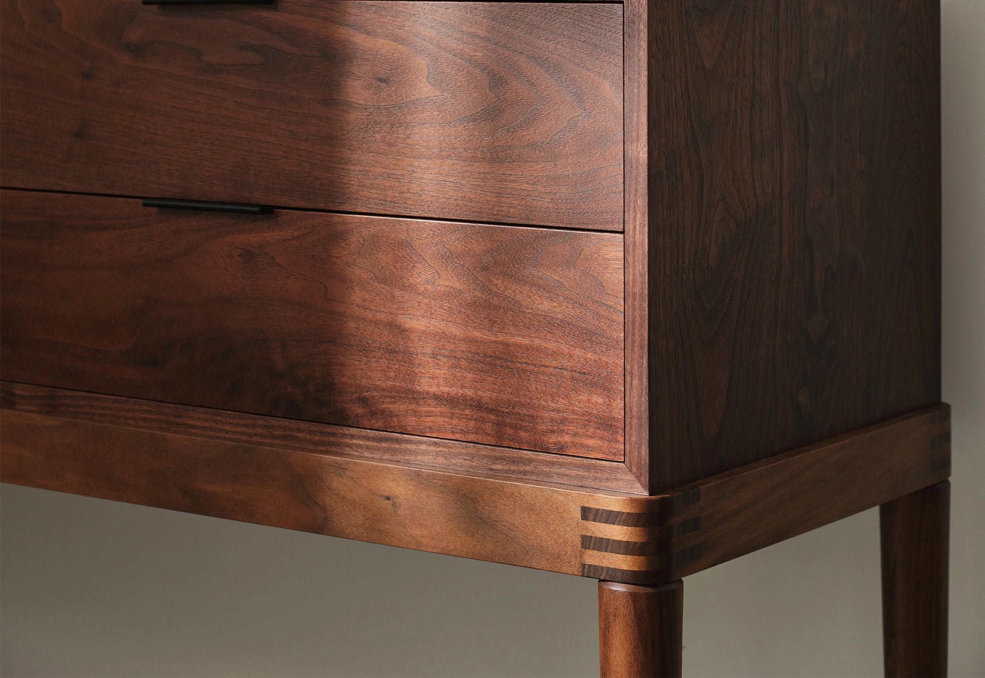 Close-up of a wooden dresser with a focus on the grain and texture.