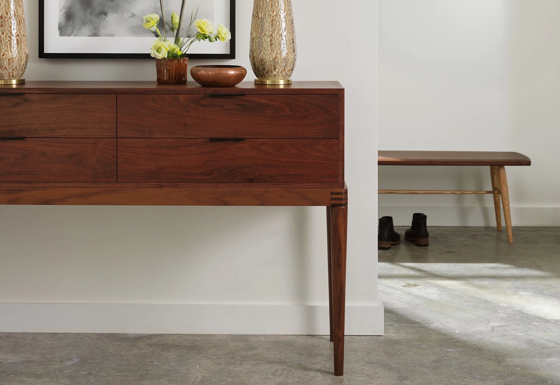 Wooden console table with decorative items in a room setting