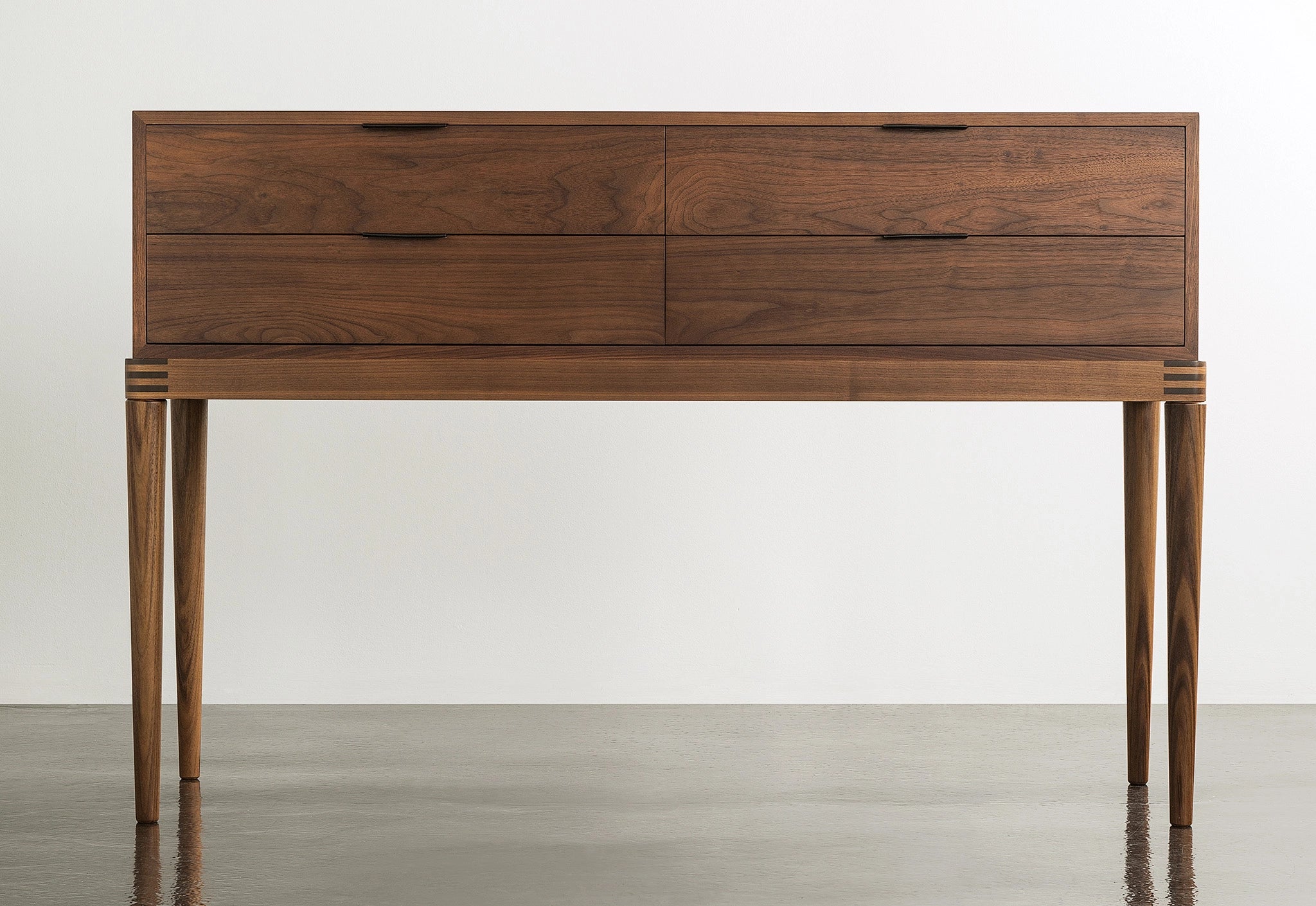 Wooden sideboard with multiple drawers on a plain background
