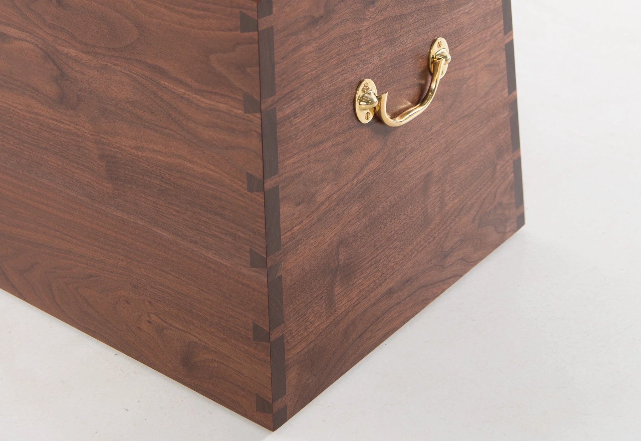 Wooden box with a brass handle on a white background