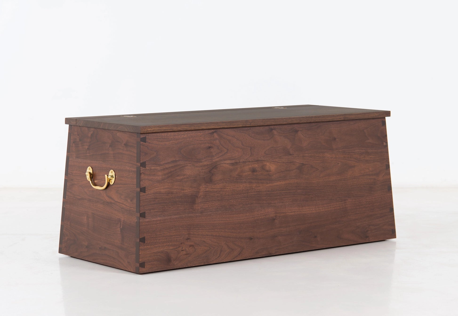 Wooden chest with a brass handle on a white background