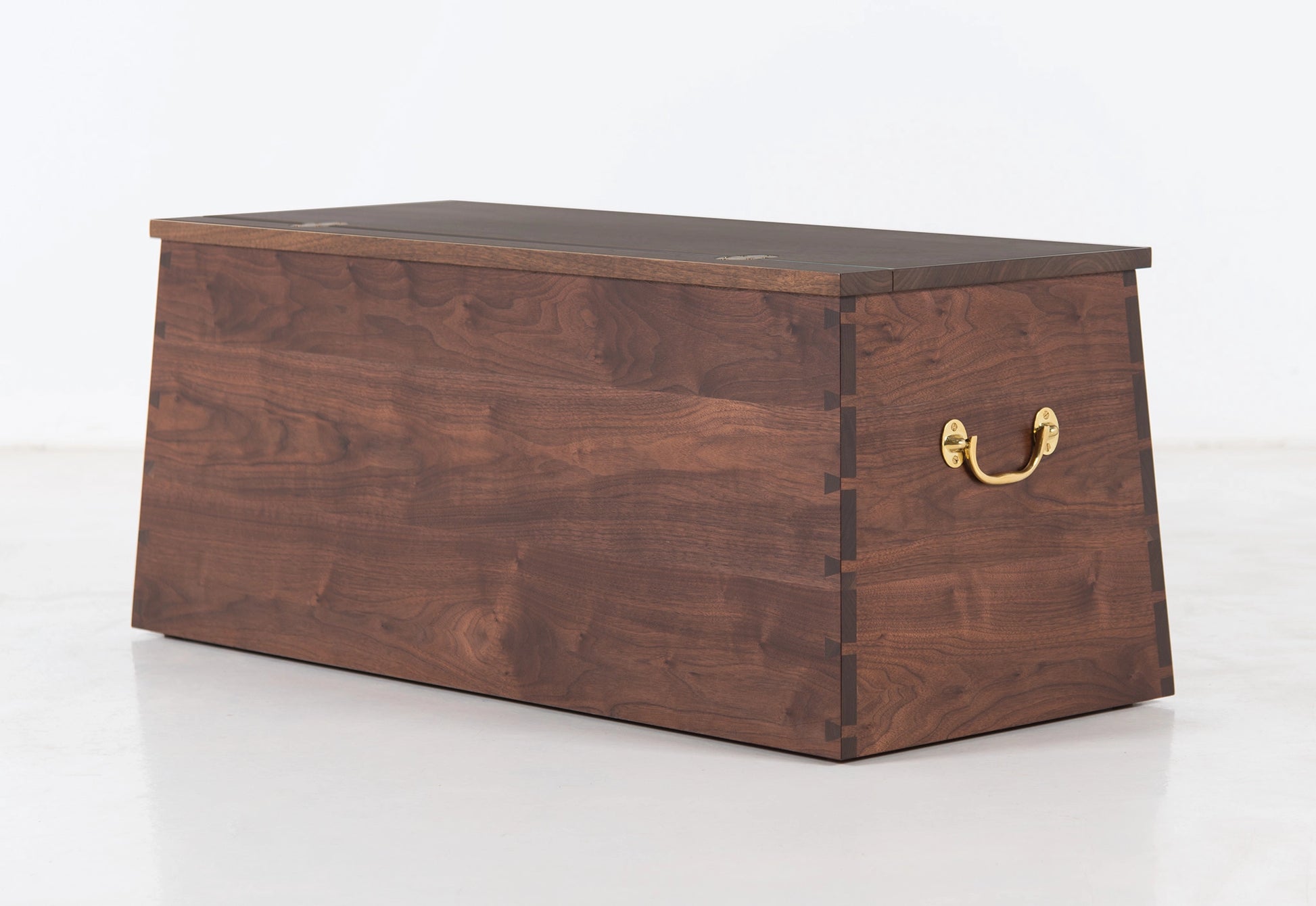 Wooden chest with a gold handle on a white background