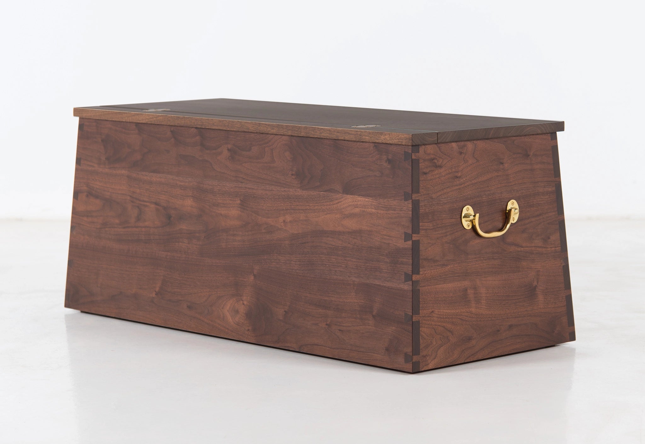 Wooden chest with a gold handle on a white background