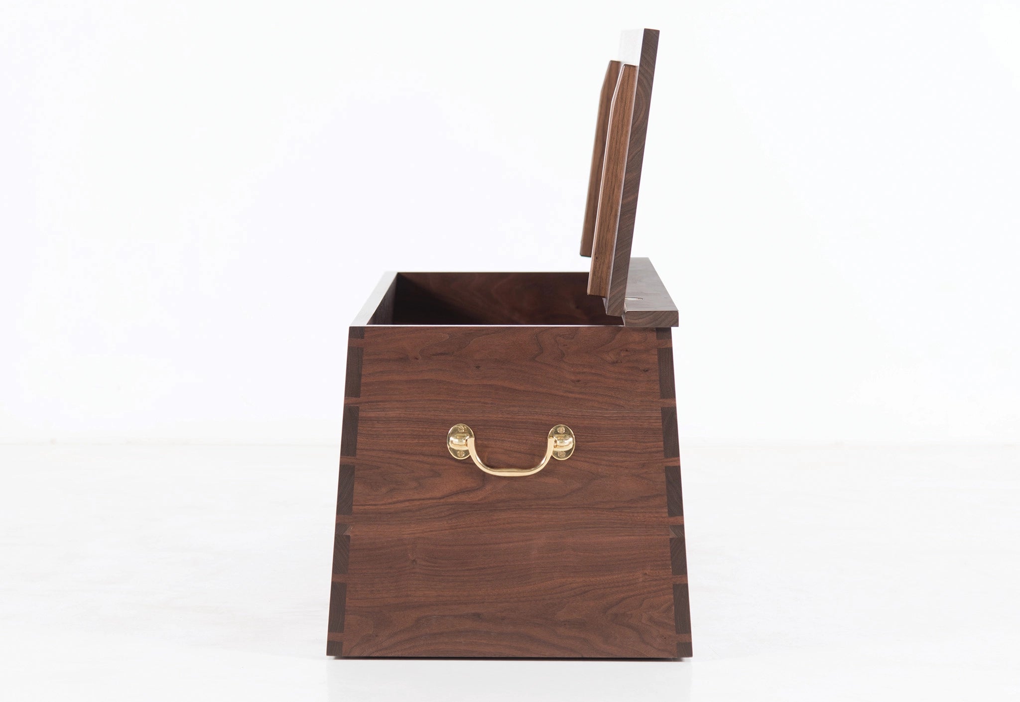 Wooden box with a gold handle on a white background
