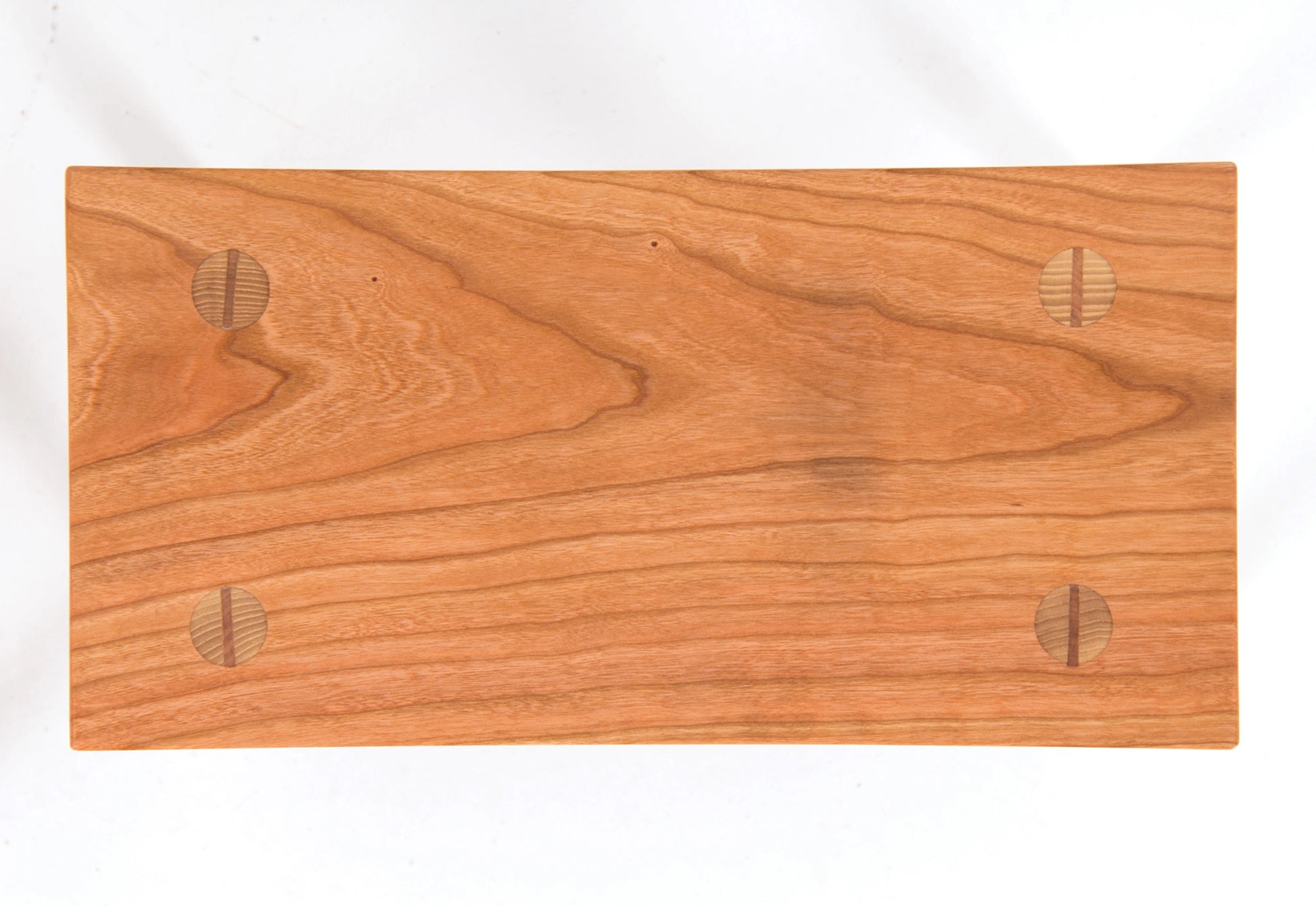 Wooden foot stool with a smooth finish on a white background
