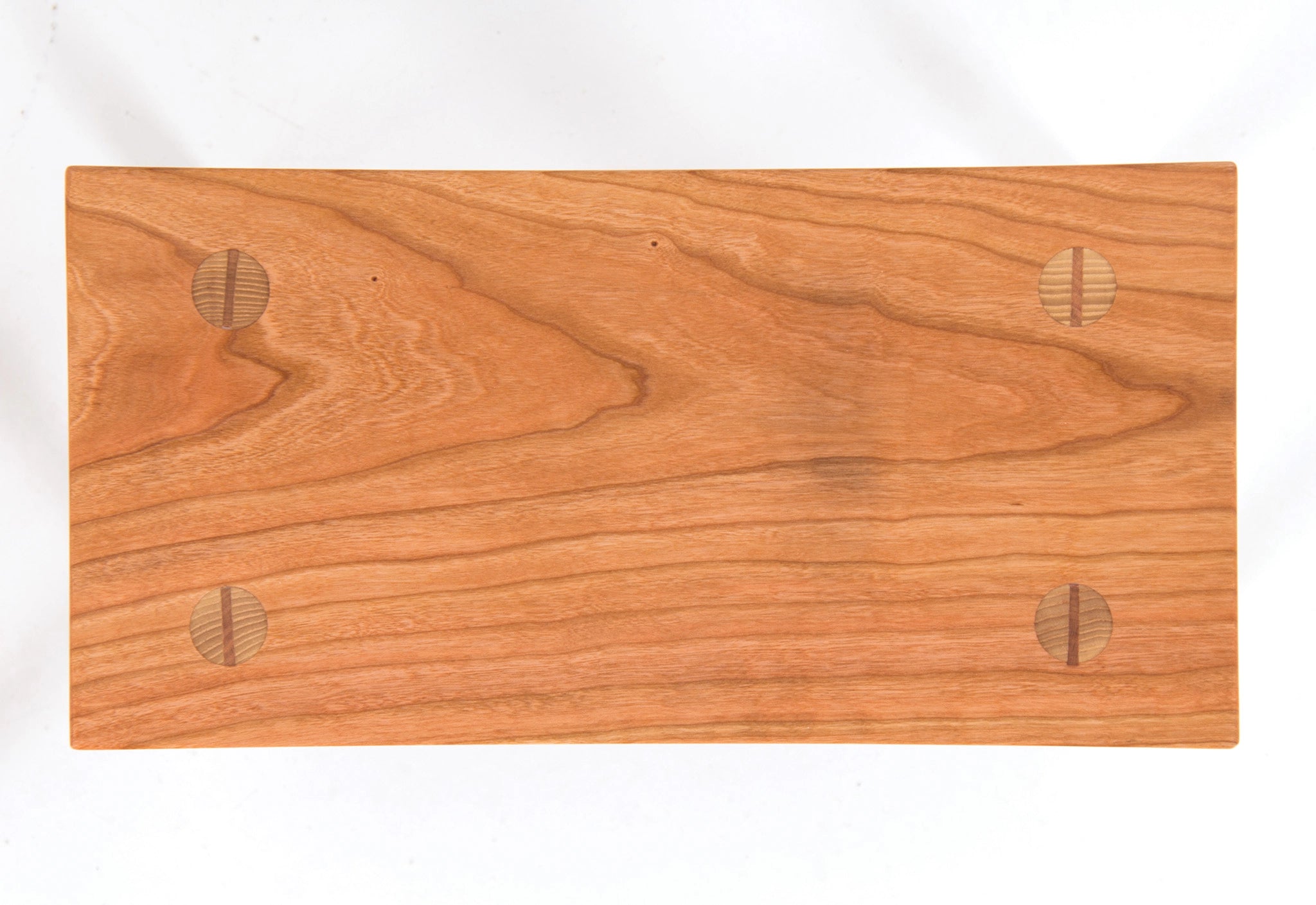 Wooden foot stool with a smooth finish on a white background