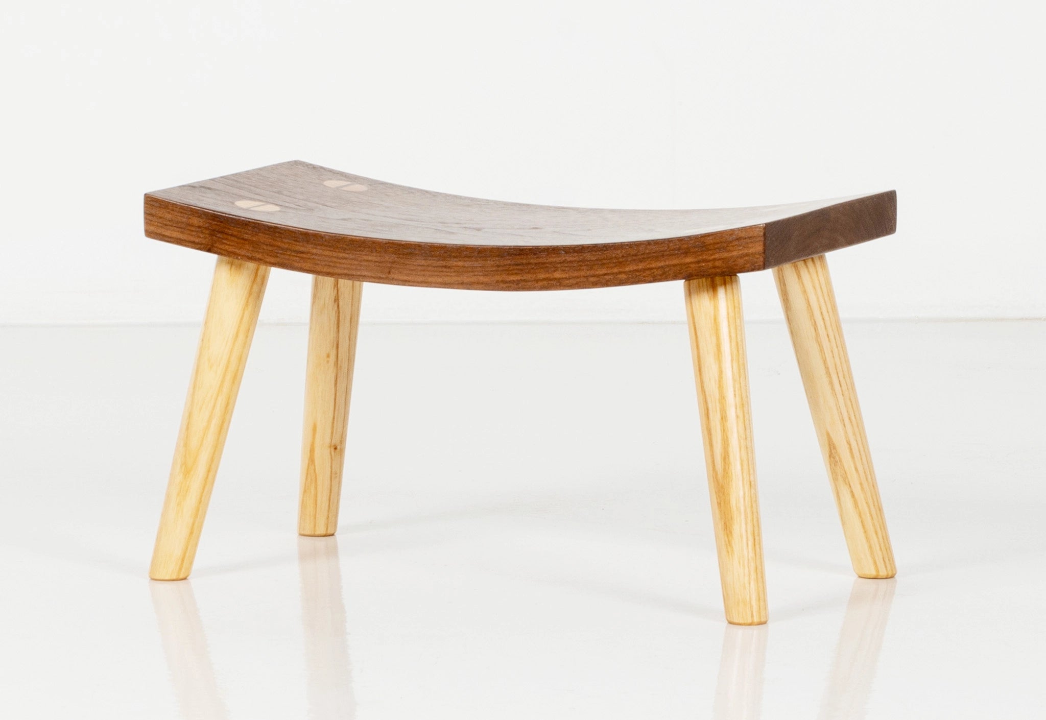 Wooden stool with a curved design on a white background