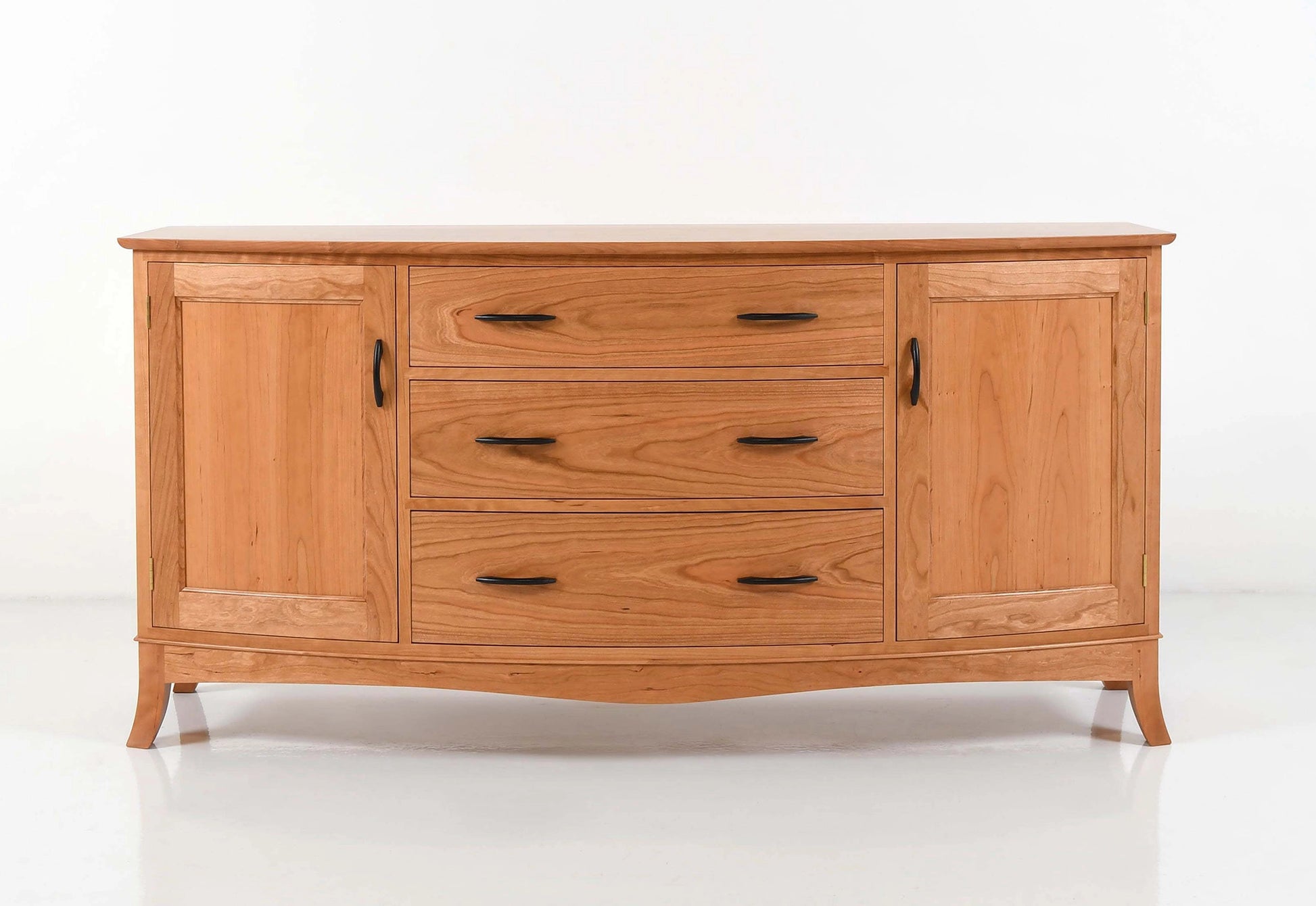 Wooden sideboard with multiple drawers and doors on a white background