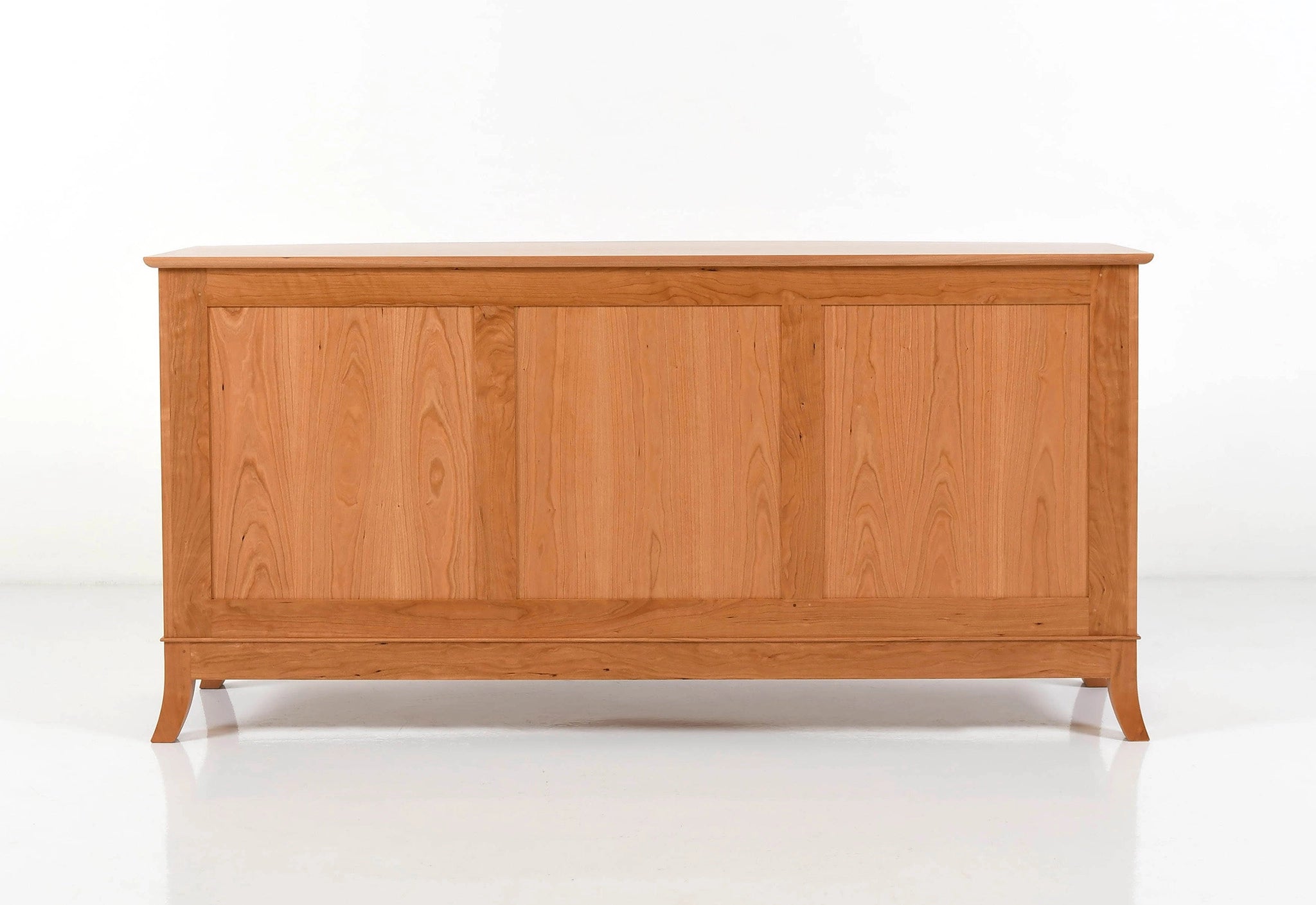 Back of a wooden sideboard with a white background