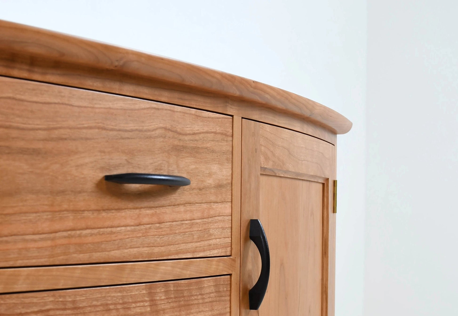 Wooden Sideboard with black handles on a white background