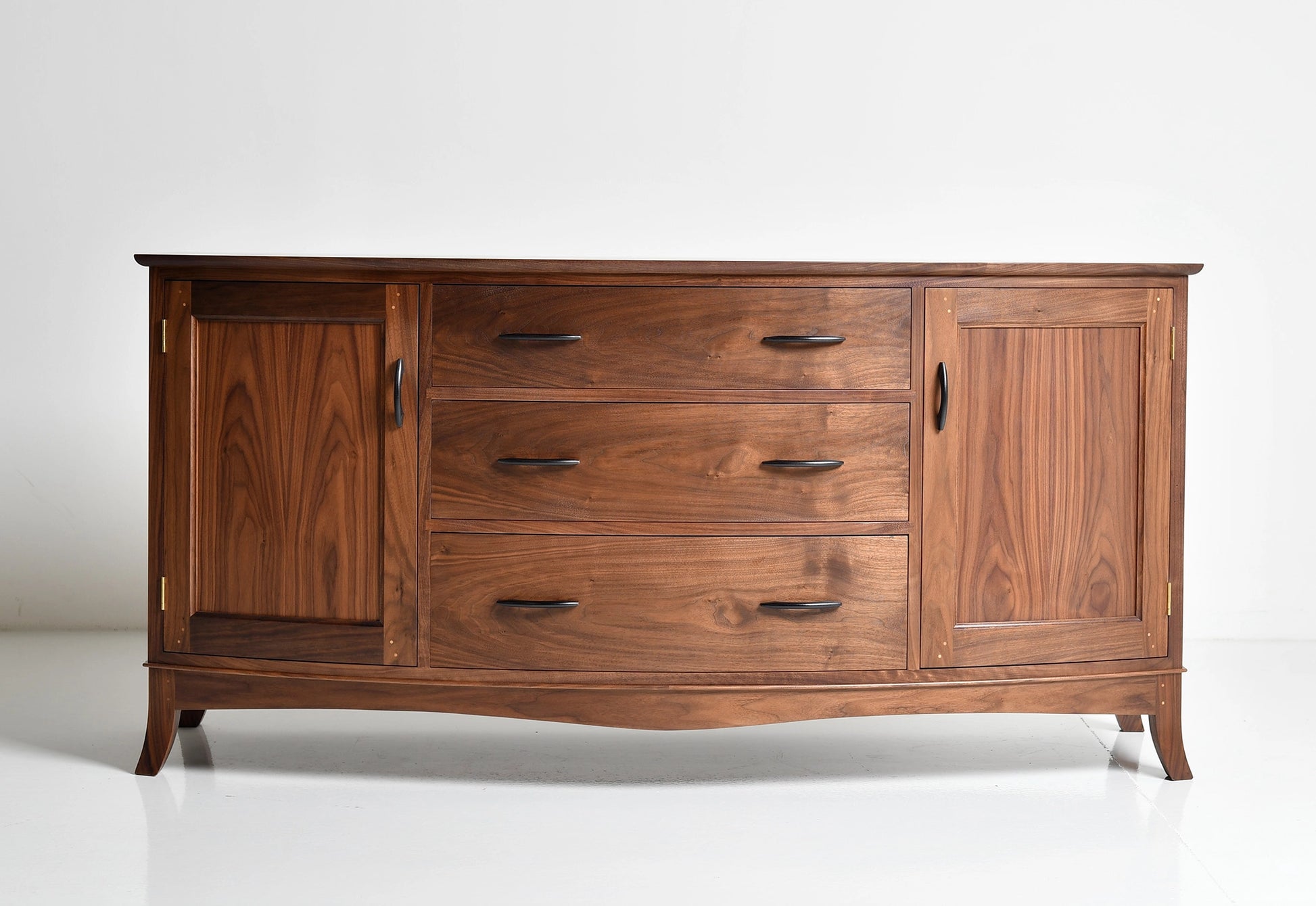 Wooden dresser with multiple drawers and doors on a white background