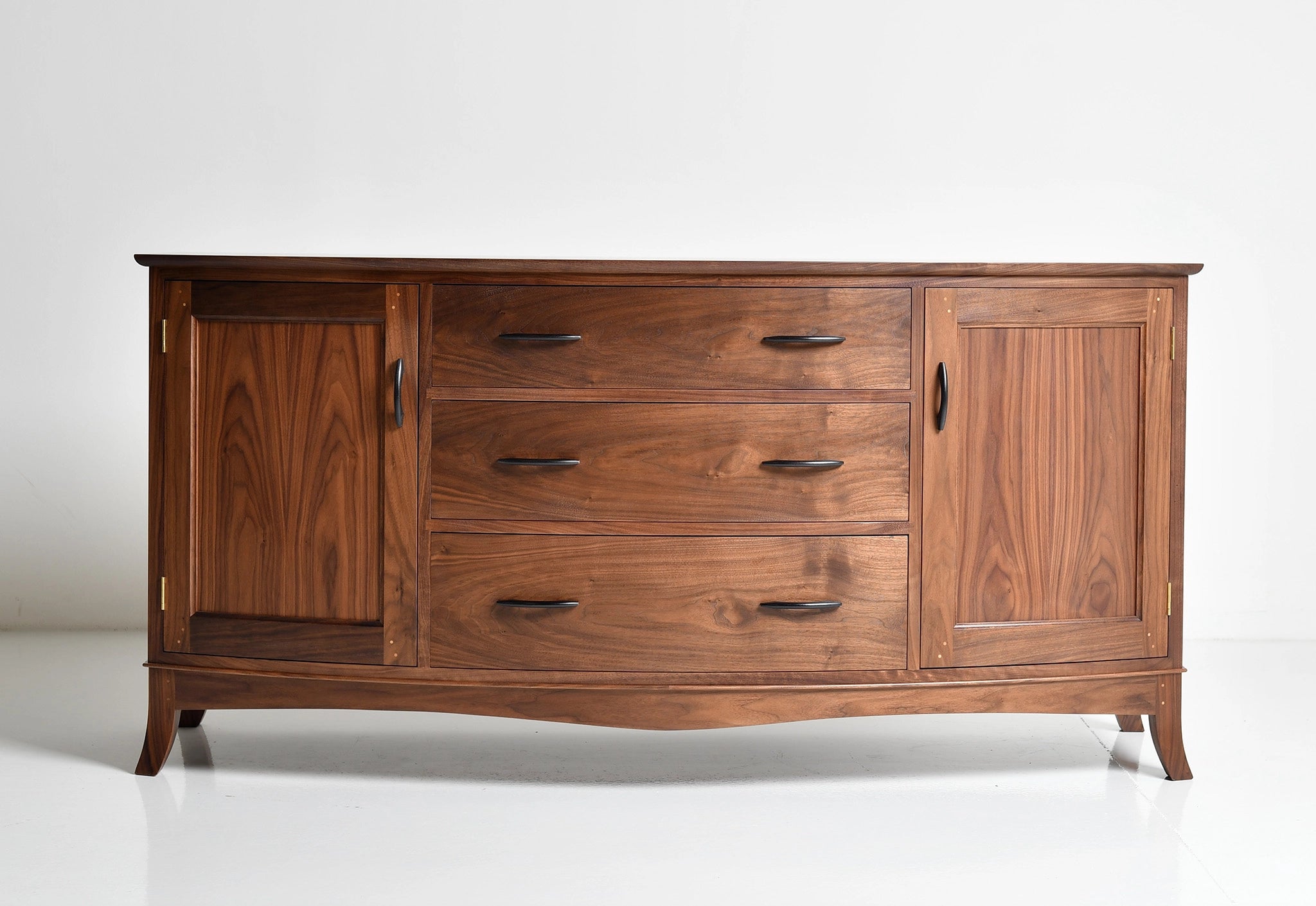 Wooden dresser with multiple drawers and doors on a white background