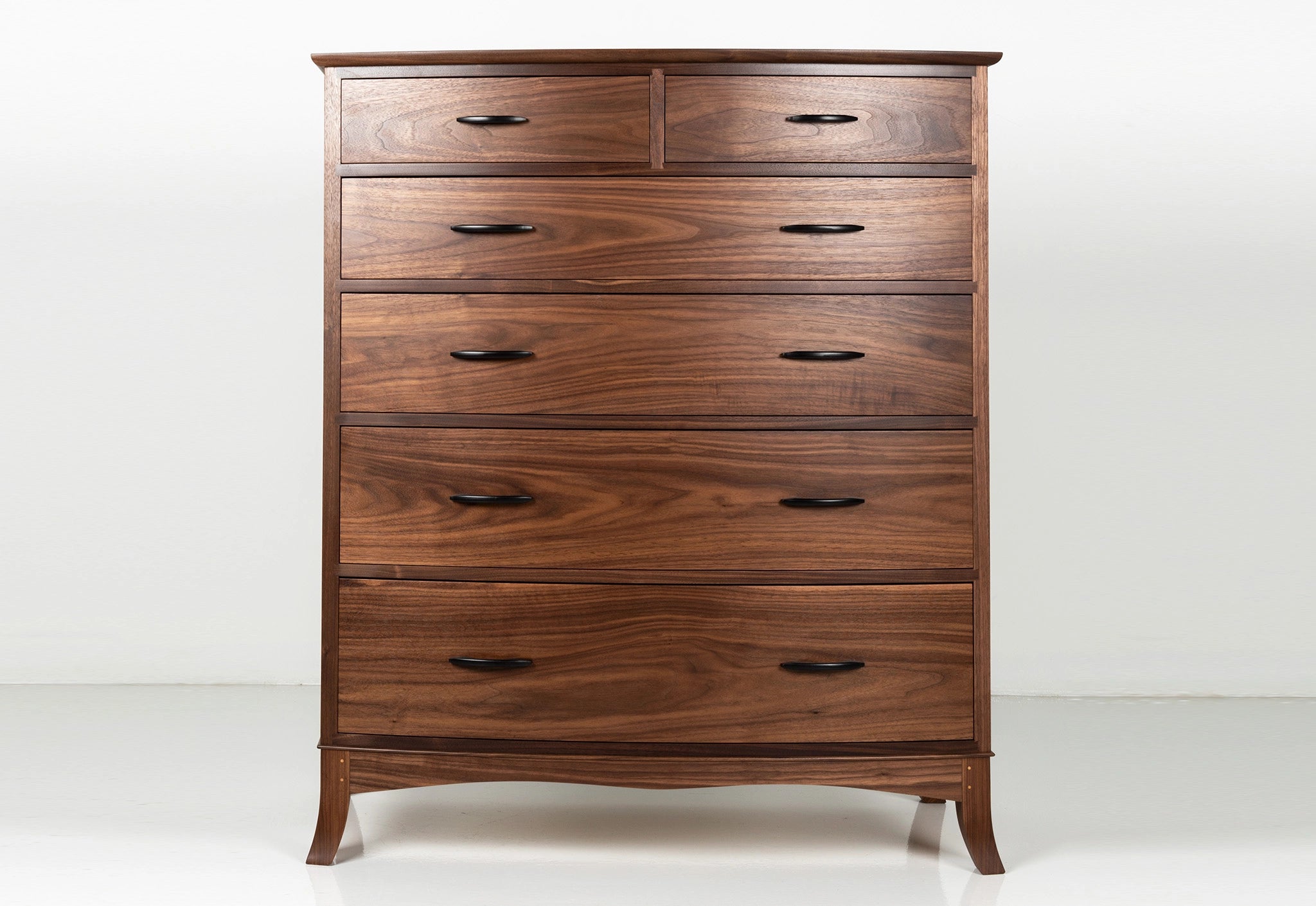 Wooden dresser with multiple drawers on a white background