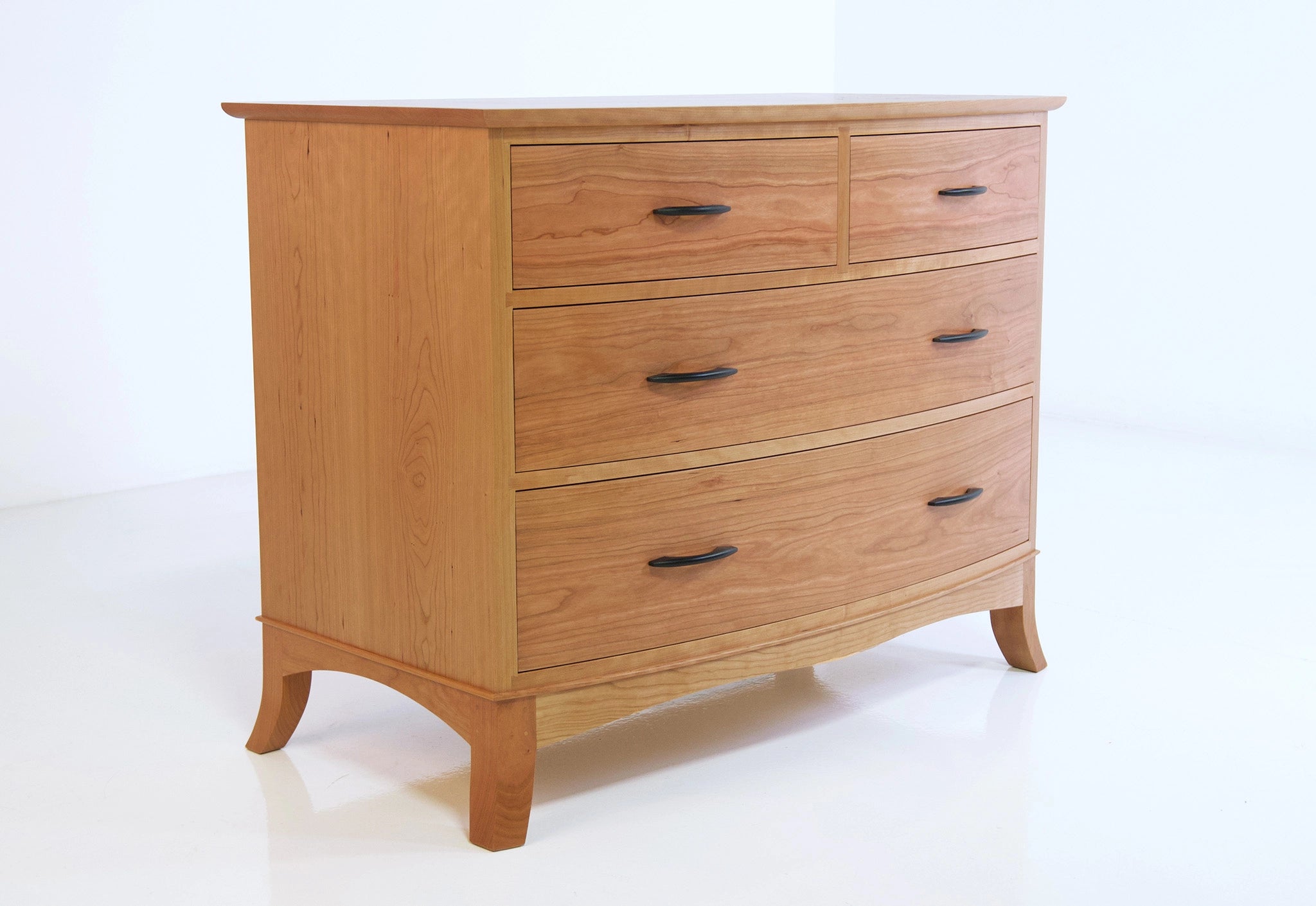 Wooden dresser with four drawers on a white background