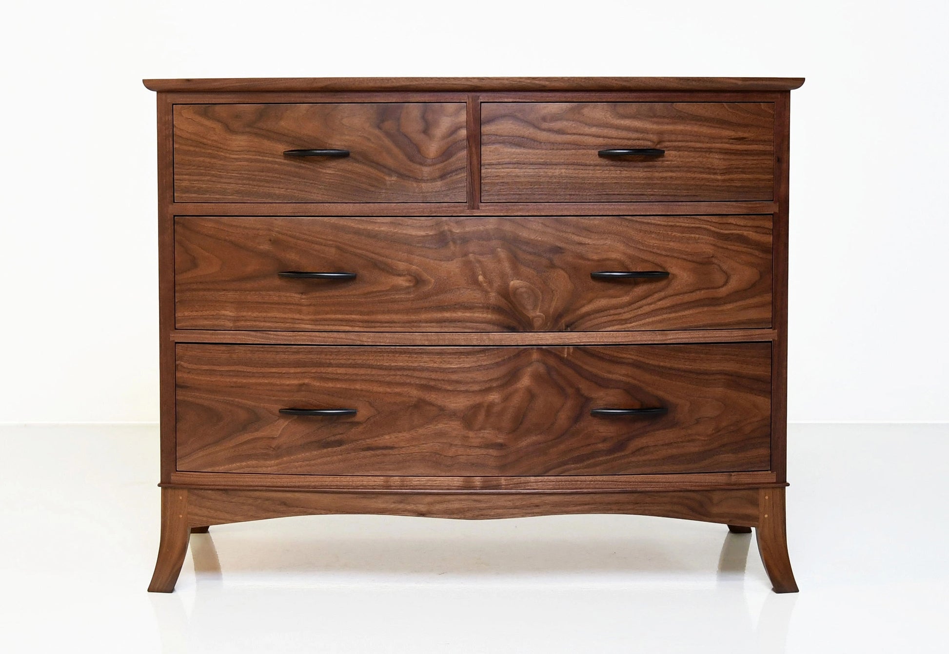 Wooden dresser with four drawers on a white background