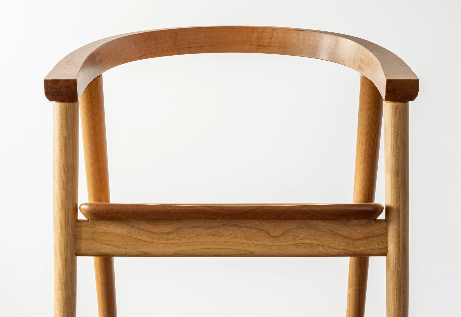 Wooden chair with a curved backrest on a white background