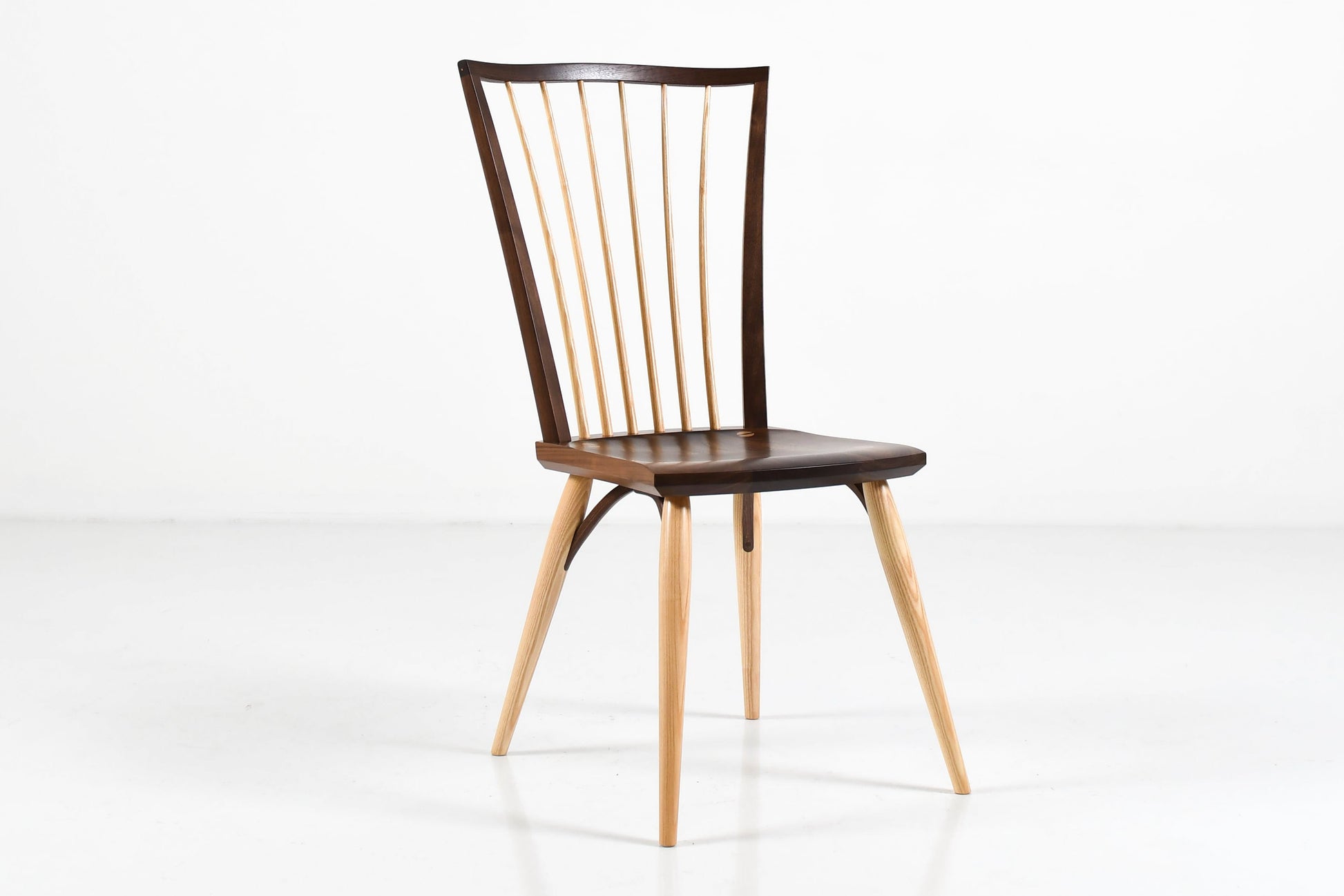 Wooden chair with a black seat on a white background