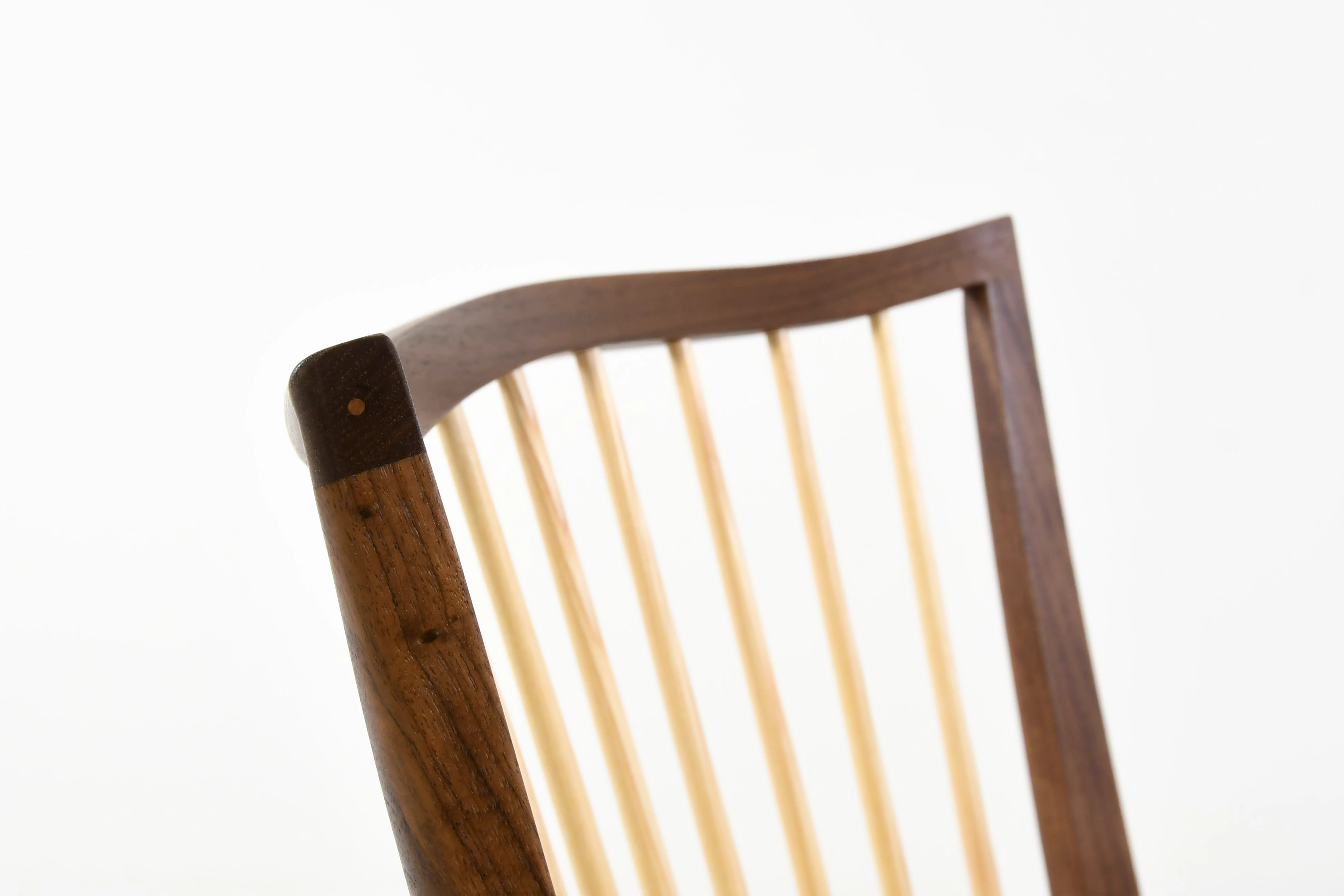 Wooden chair with spindle backrest on a white background