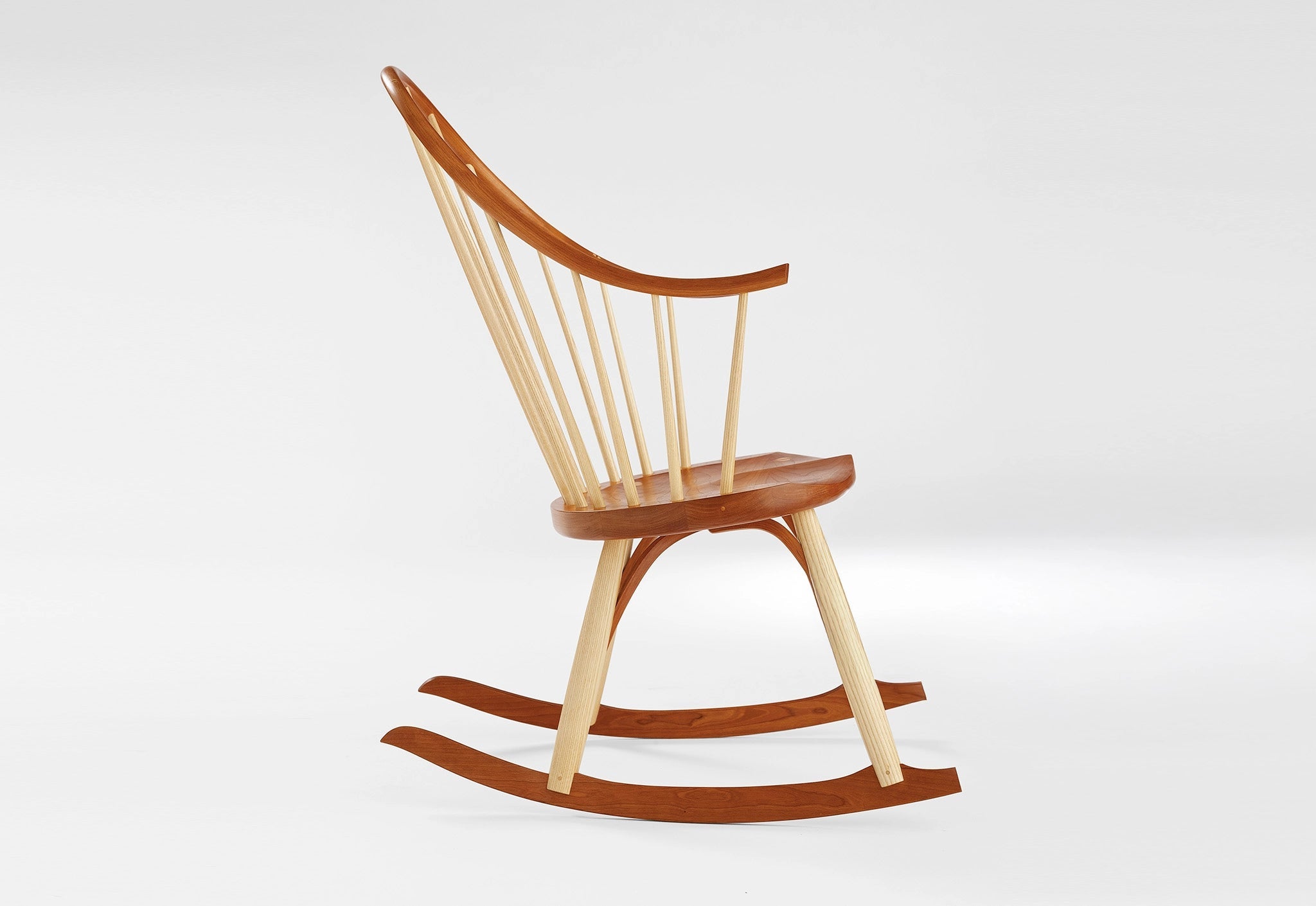 Wooden rocking chair on a white background