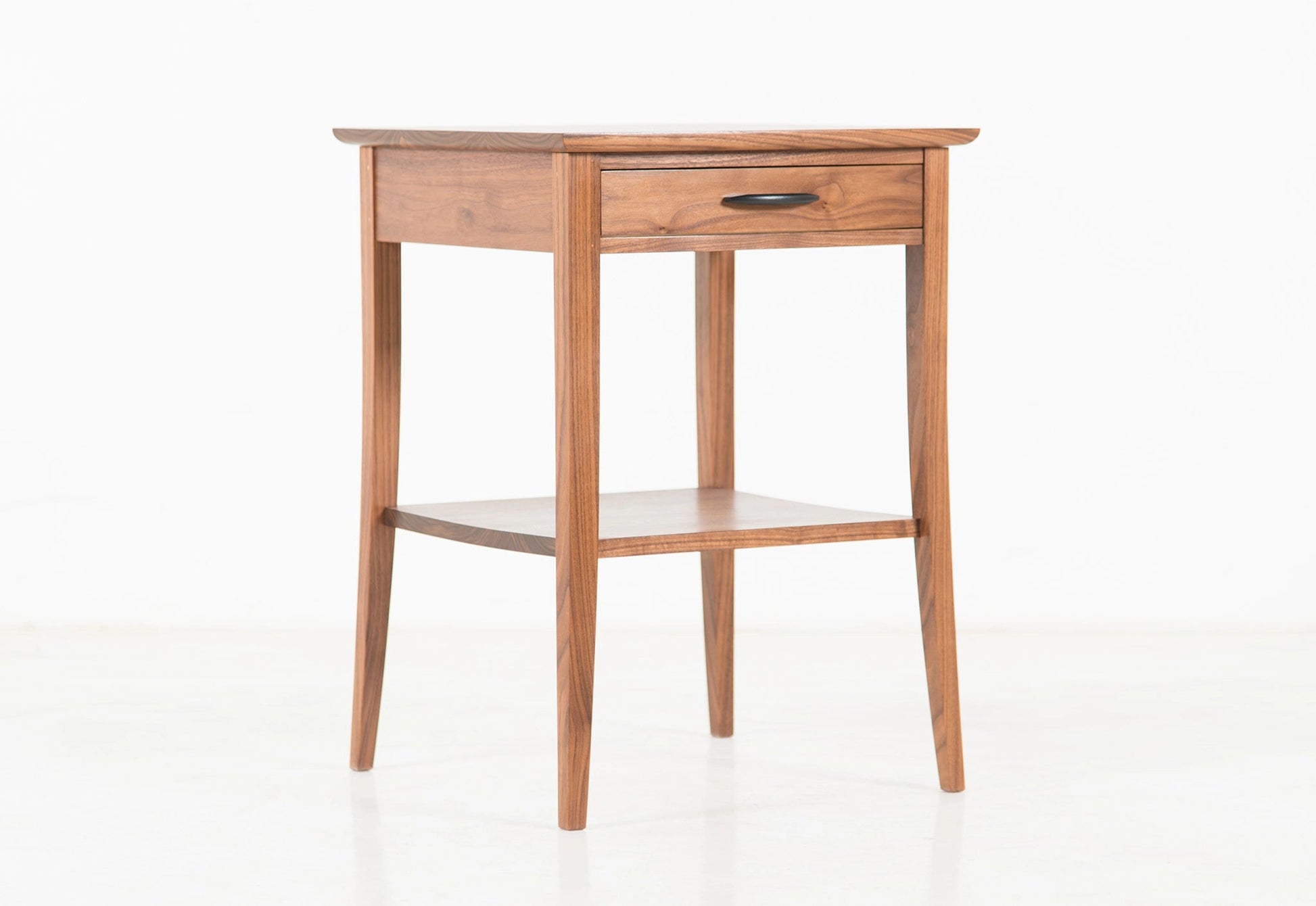 Wooden side table with a drawer on a white background