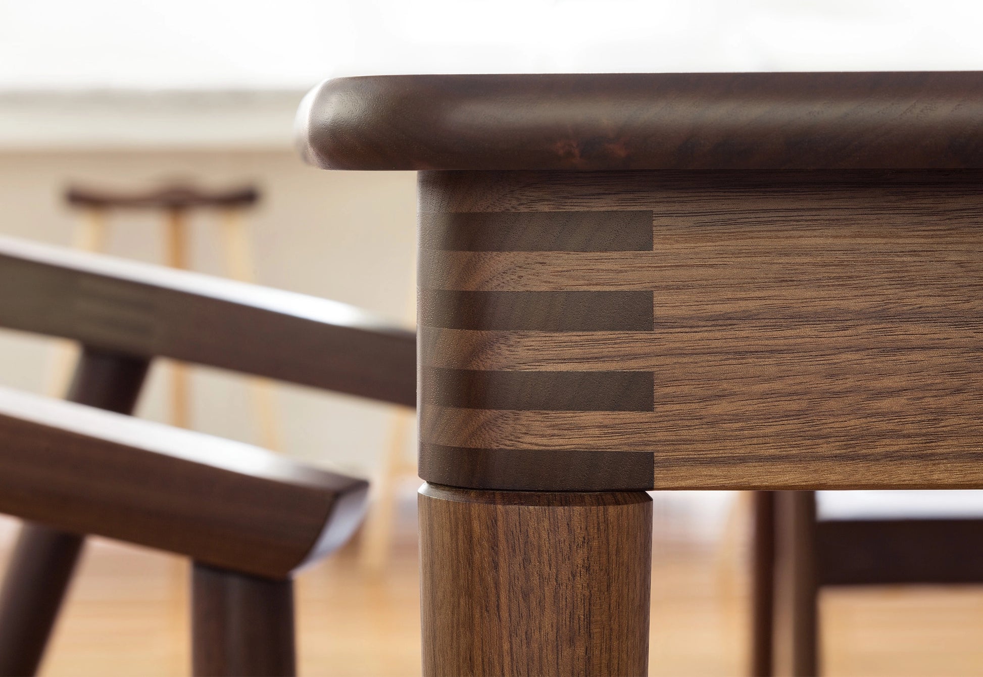 Close-up of a wooden chair with a blurred background