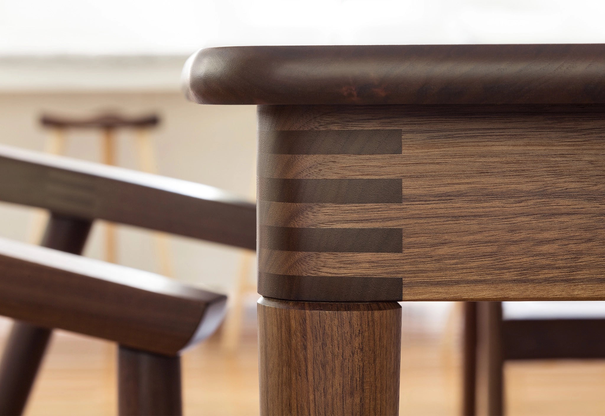 Close-up of a wooden chair with a blurred background
