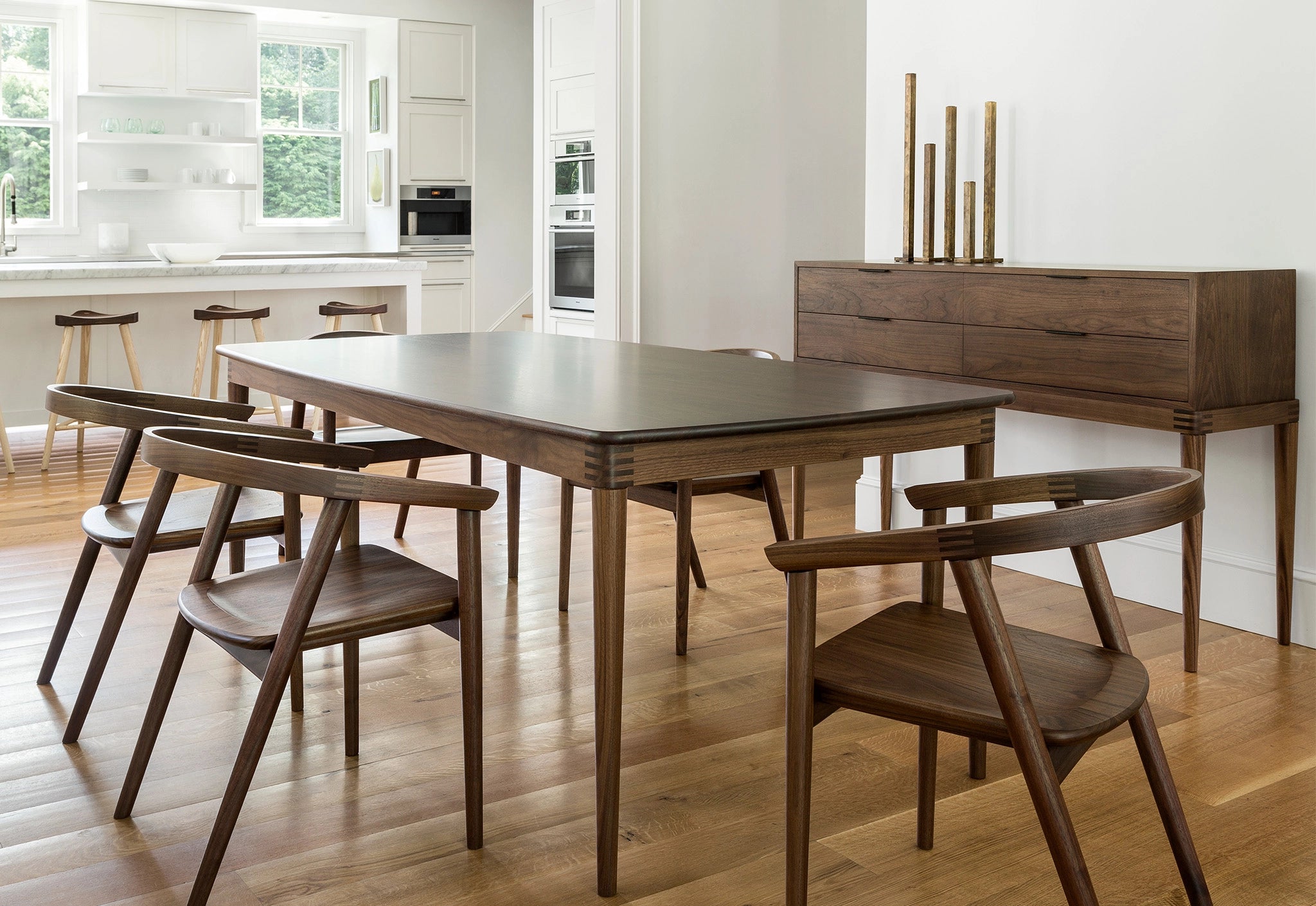 Wooden dining table with chairs in a modern kitchen setting