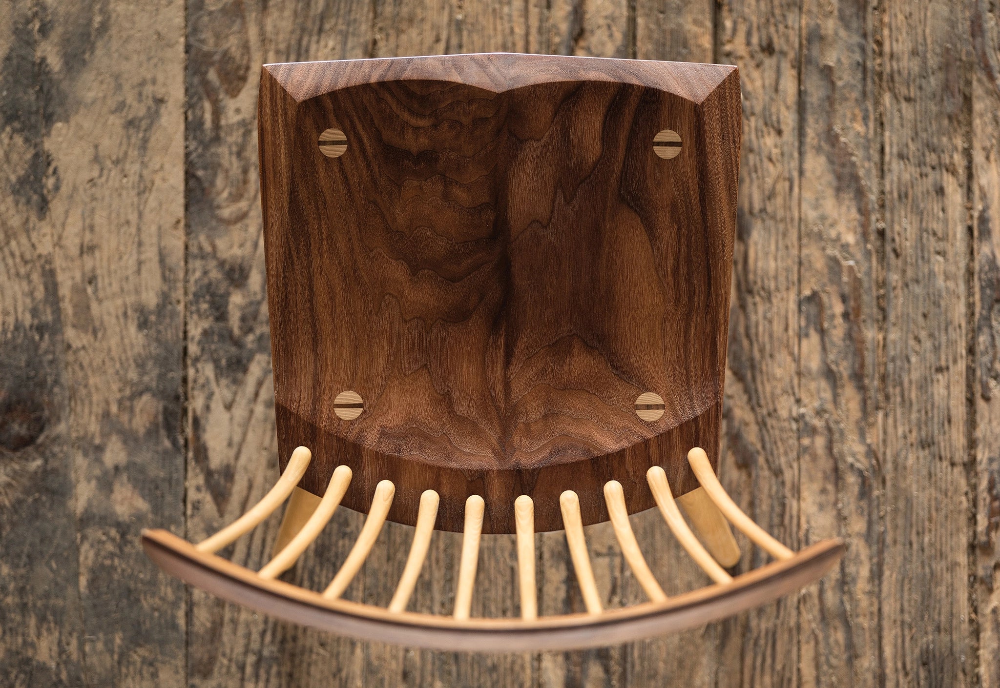 Wooden comb with a wooden handle on a wooden background