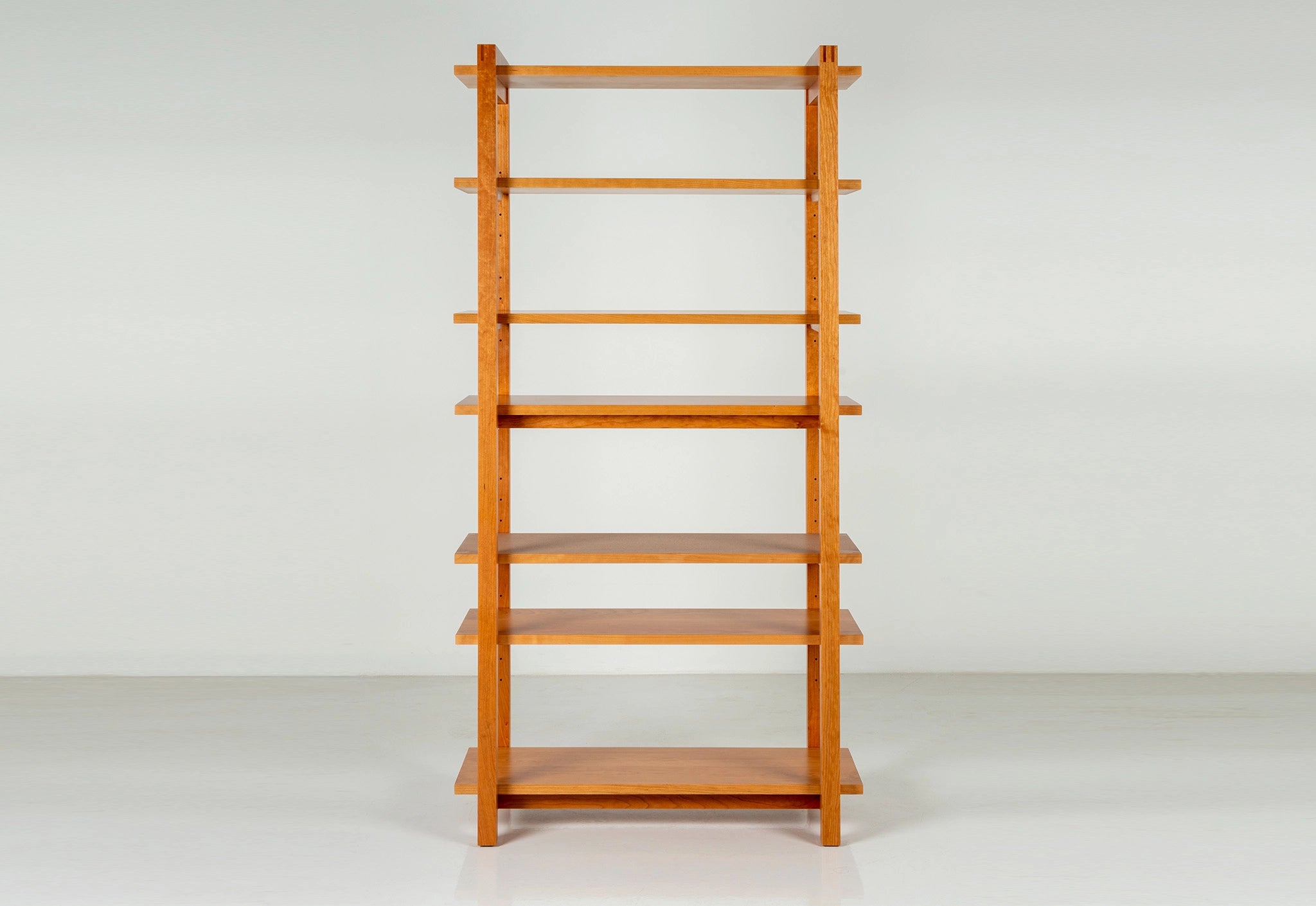 Wooden bookshelf on a white background