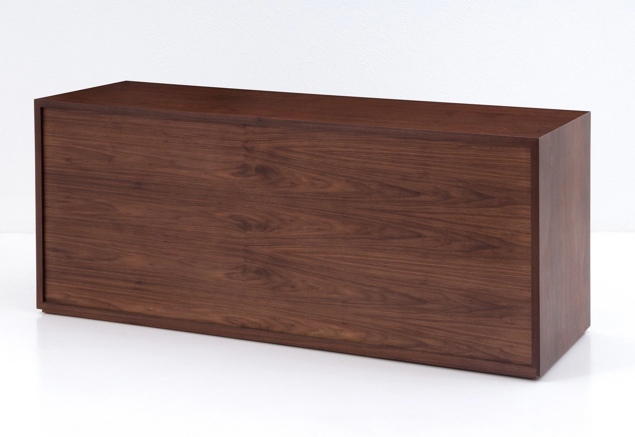 Wooden file case with black leather-faced drawers on a white background