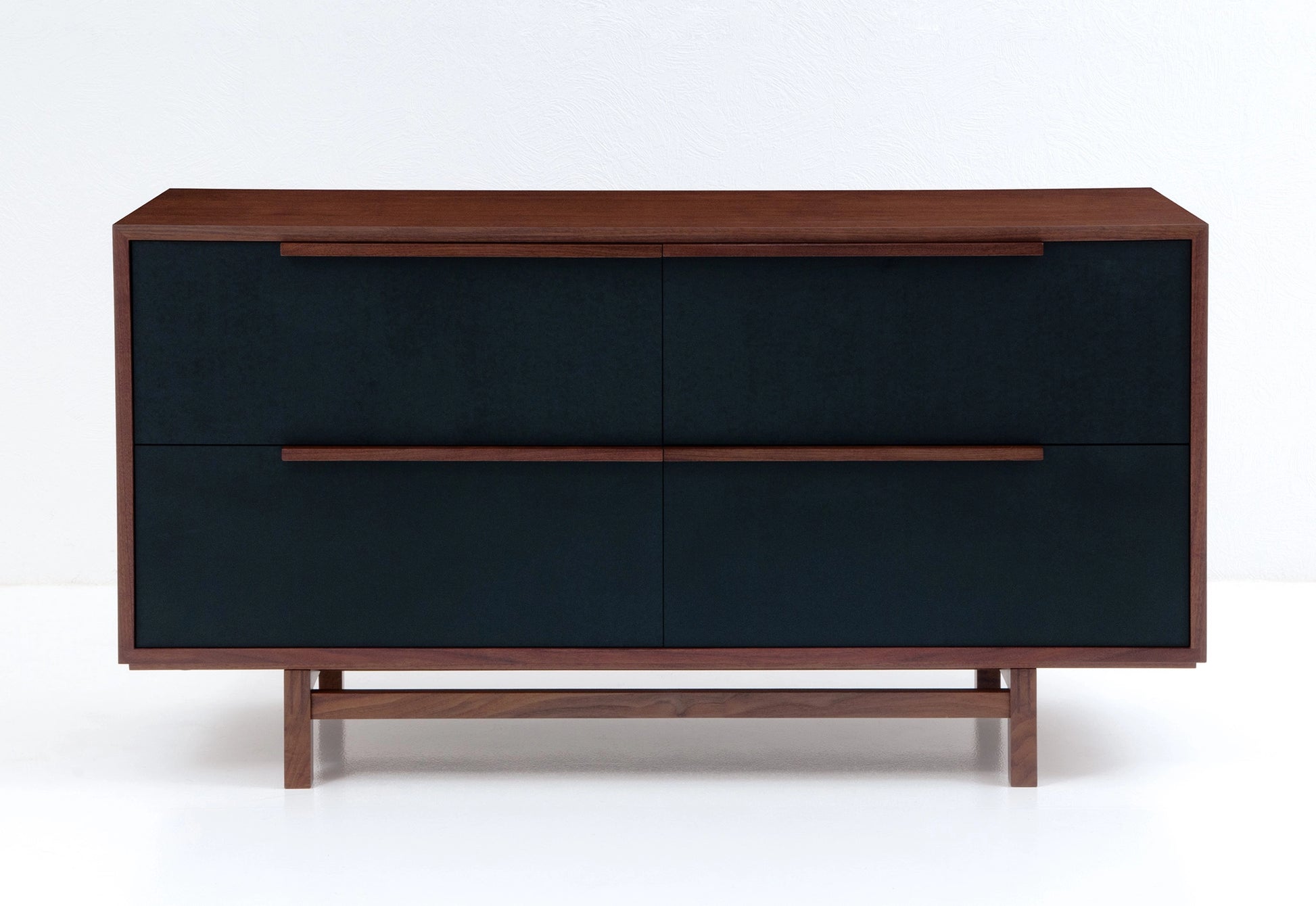 Wooden file case with black leather-faced drawers on a white background