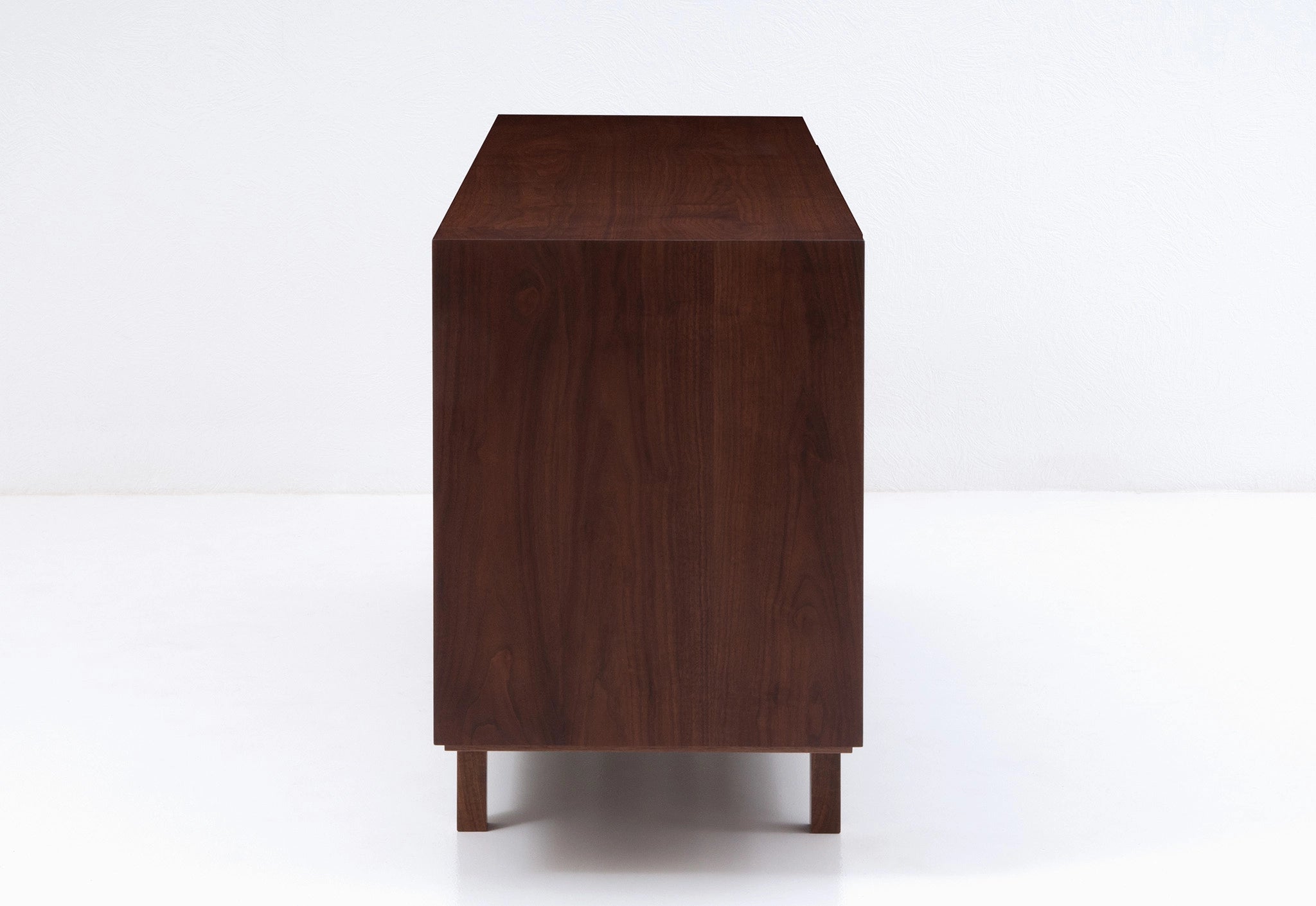 Wooden file case with black leather-faced drawers on a white background
